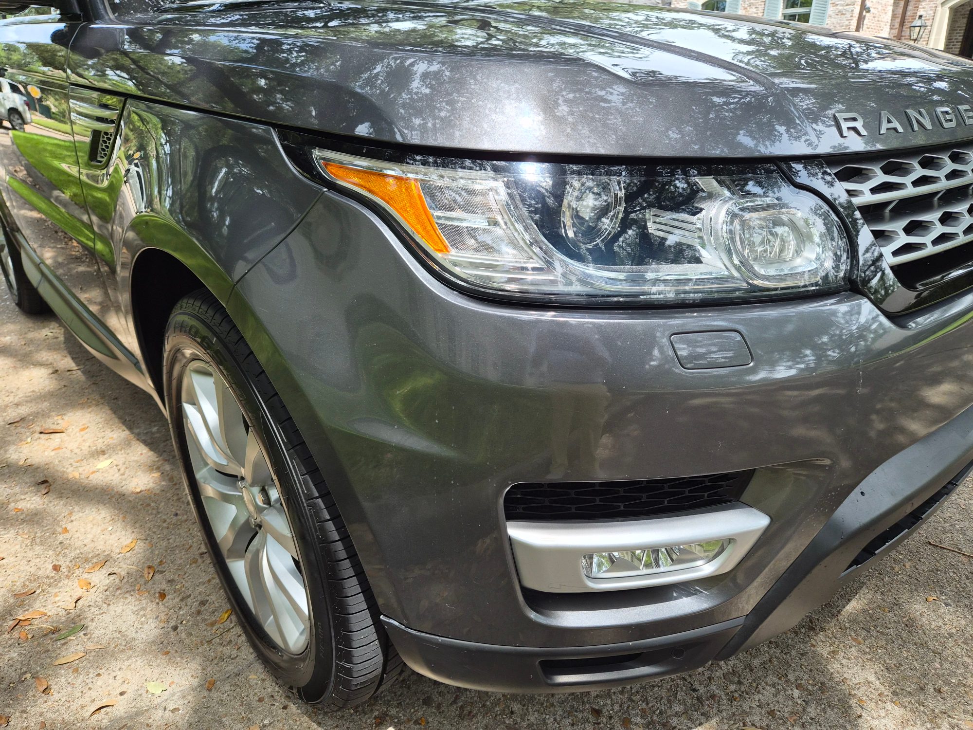 Front driver side corner showing headlight, grille, and wheel.