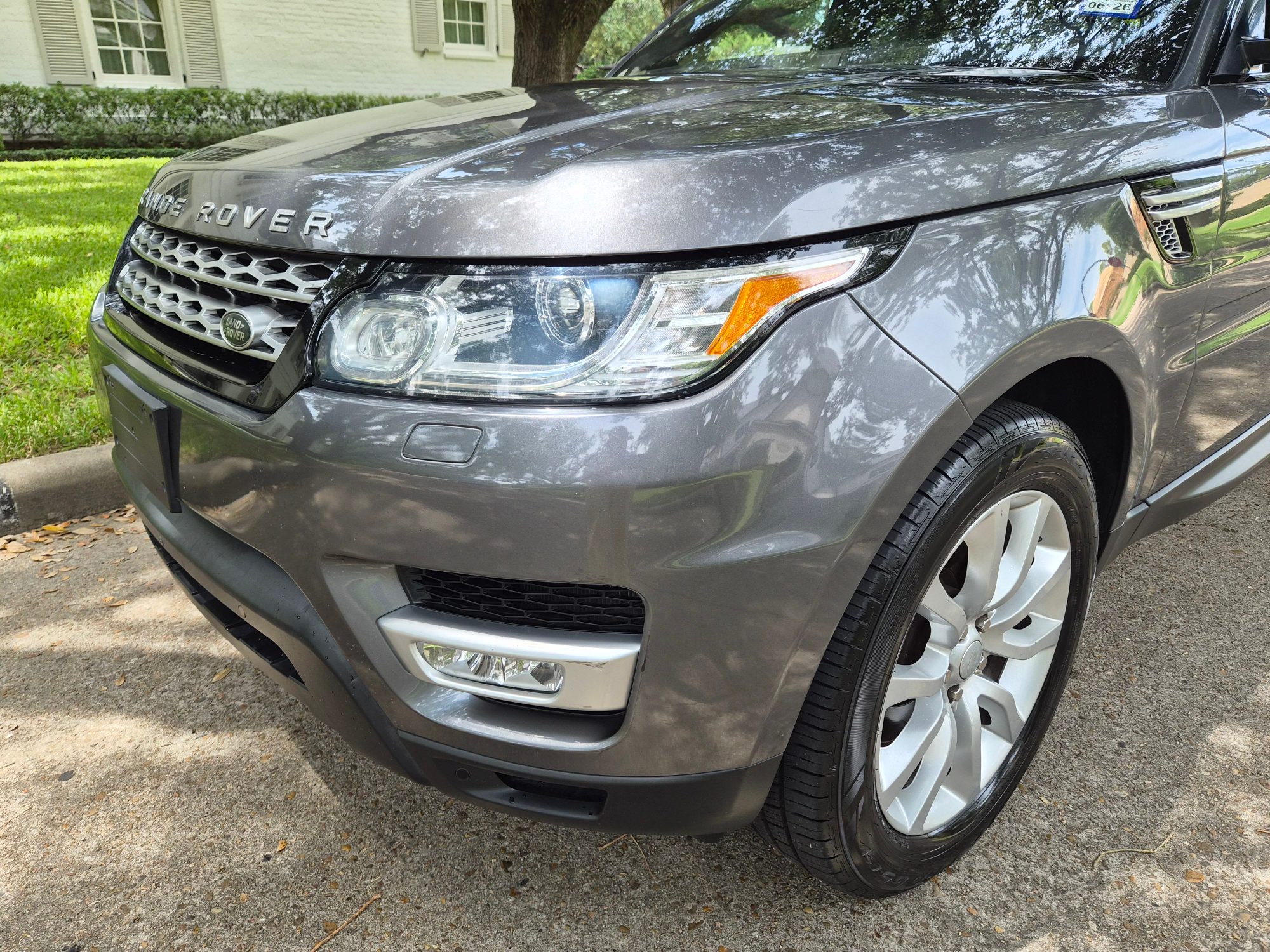 Front three-quarter view of the passenger side headlight and wheel.