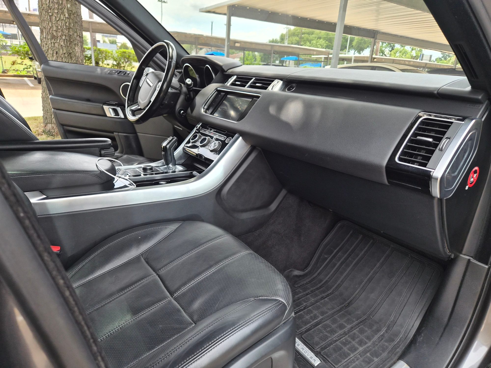 Passenger side view of black leather interior and dashboard.