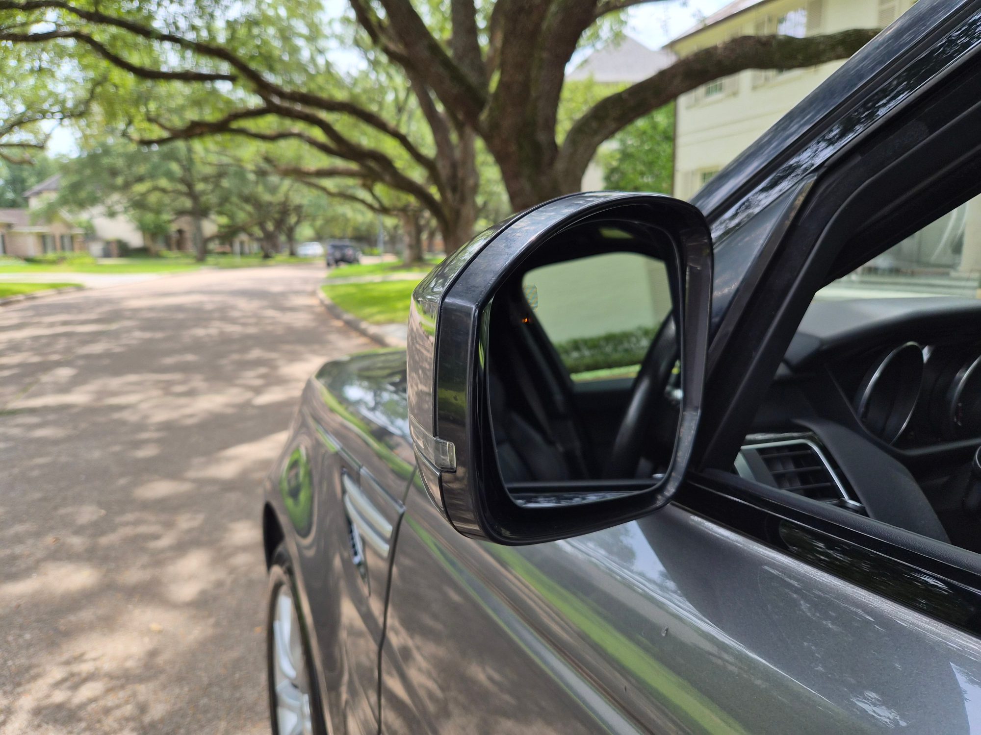 Close-up of the driver side exterior wing mirror and door frame.