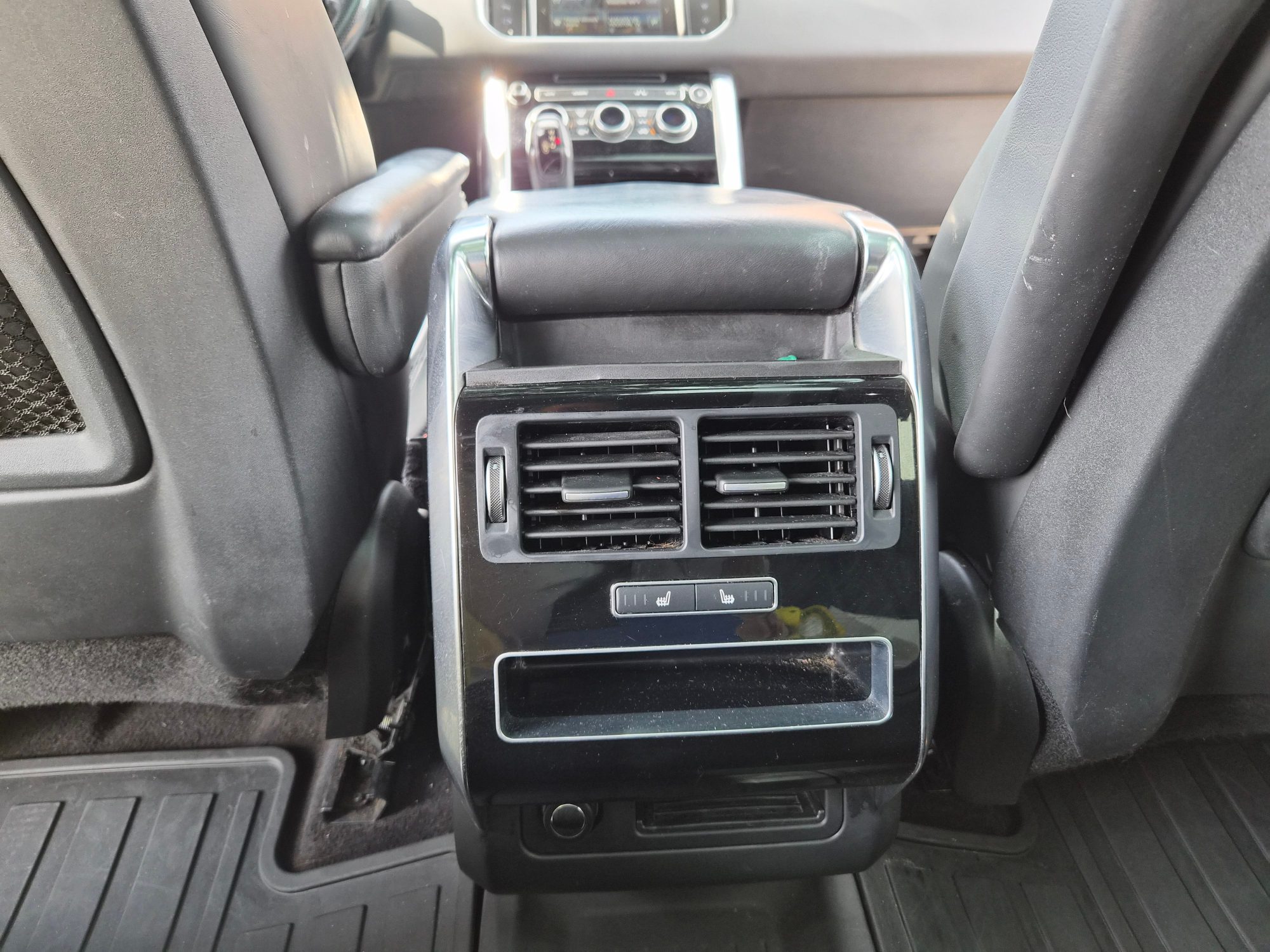 Rear center console with climate control vents and seat heater buttons.