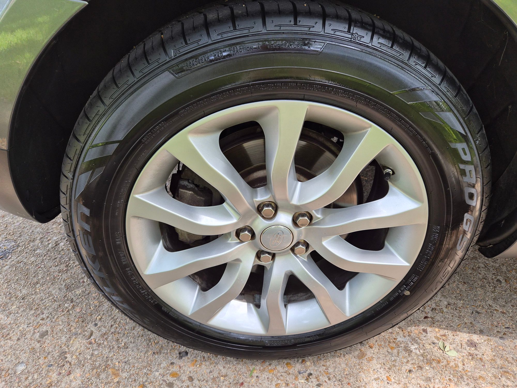 Close-up of a silver multi-spoke alloy wheel and tire.