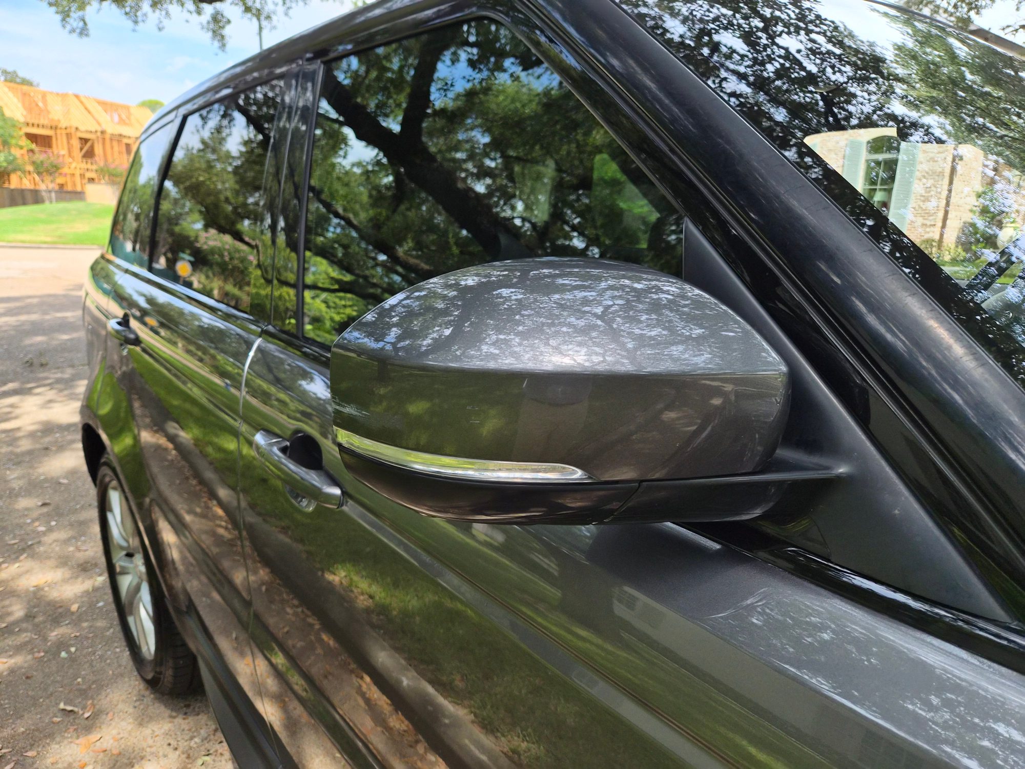 Close-up of the driver-side exterior mirror and door handles.