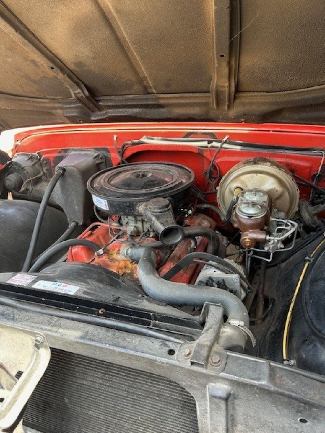 Engine bay featuring V8 motor, air cleaner, and power brake booster.