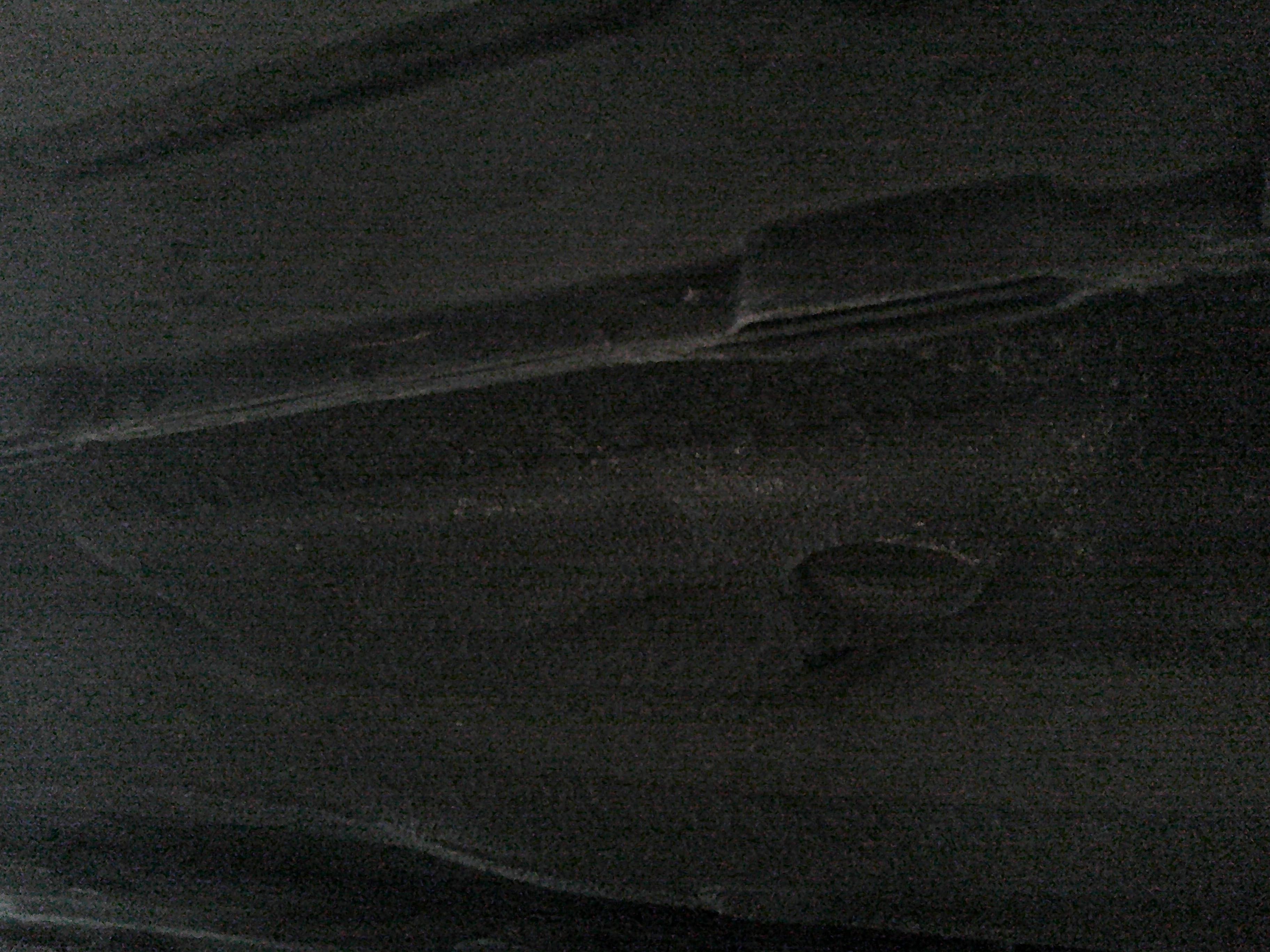 Close-up view of the vehicle floor pan and chassis surface.
