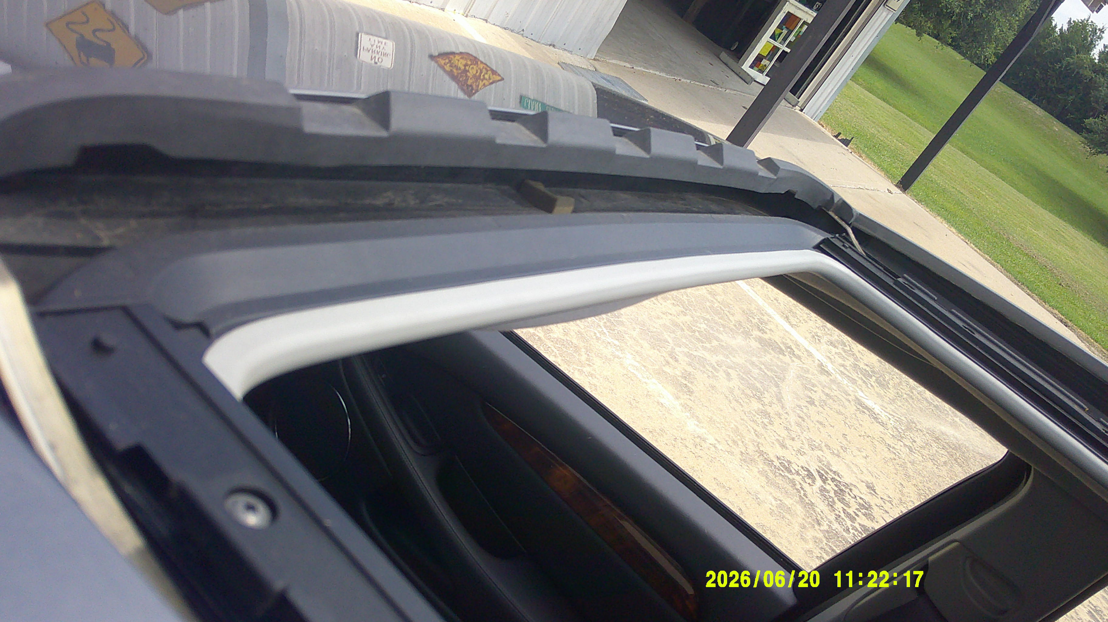Close-up of the open sunroof and roof track components