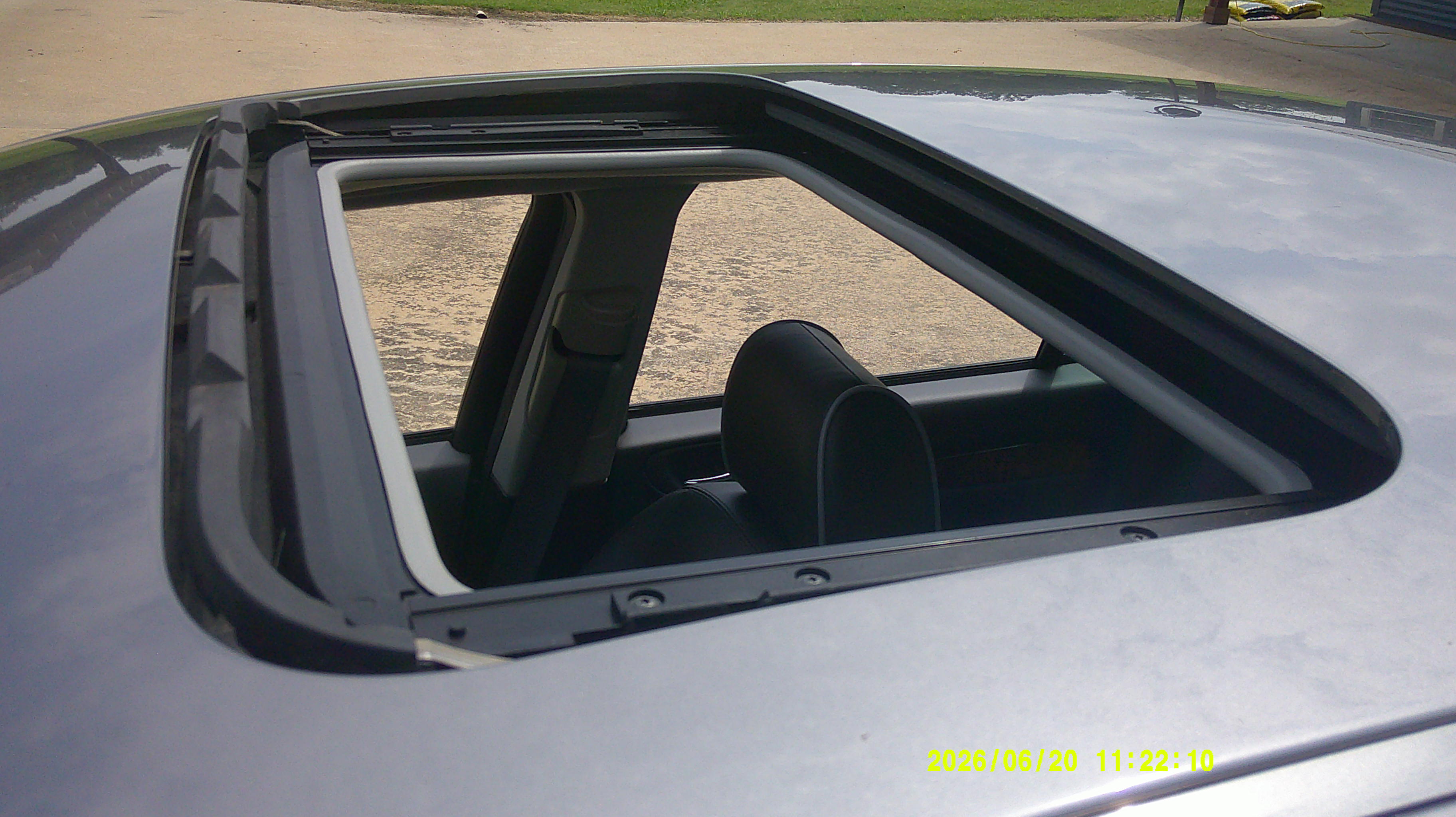 View of the open sunroof and roof panel from above.