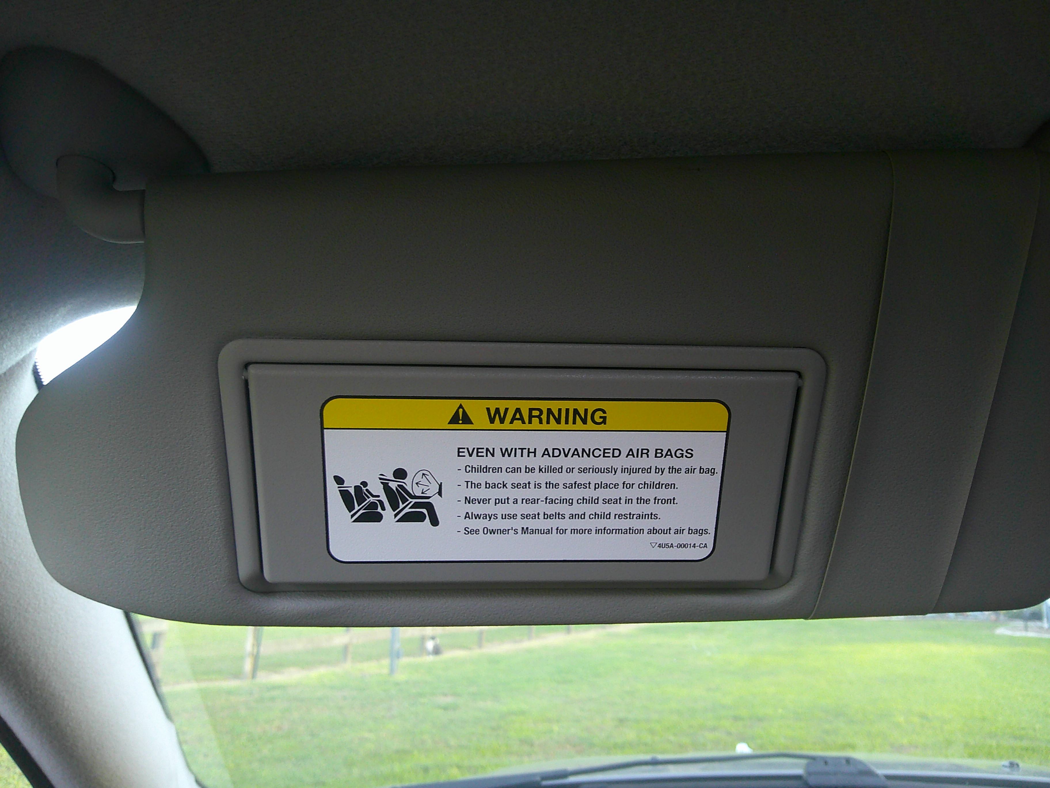 Close-up of the sun visor with airbag warning label.