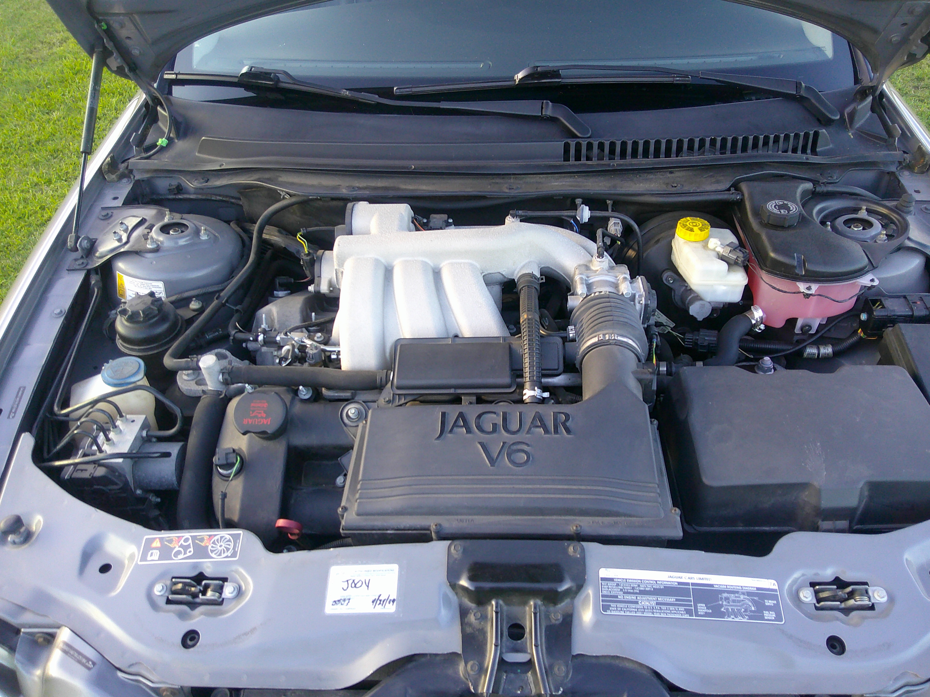 View of the Jaguar V6 engine bay with hood open.