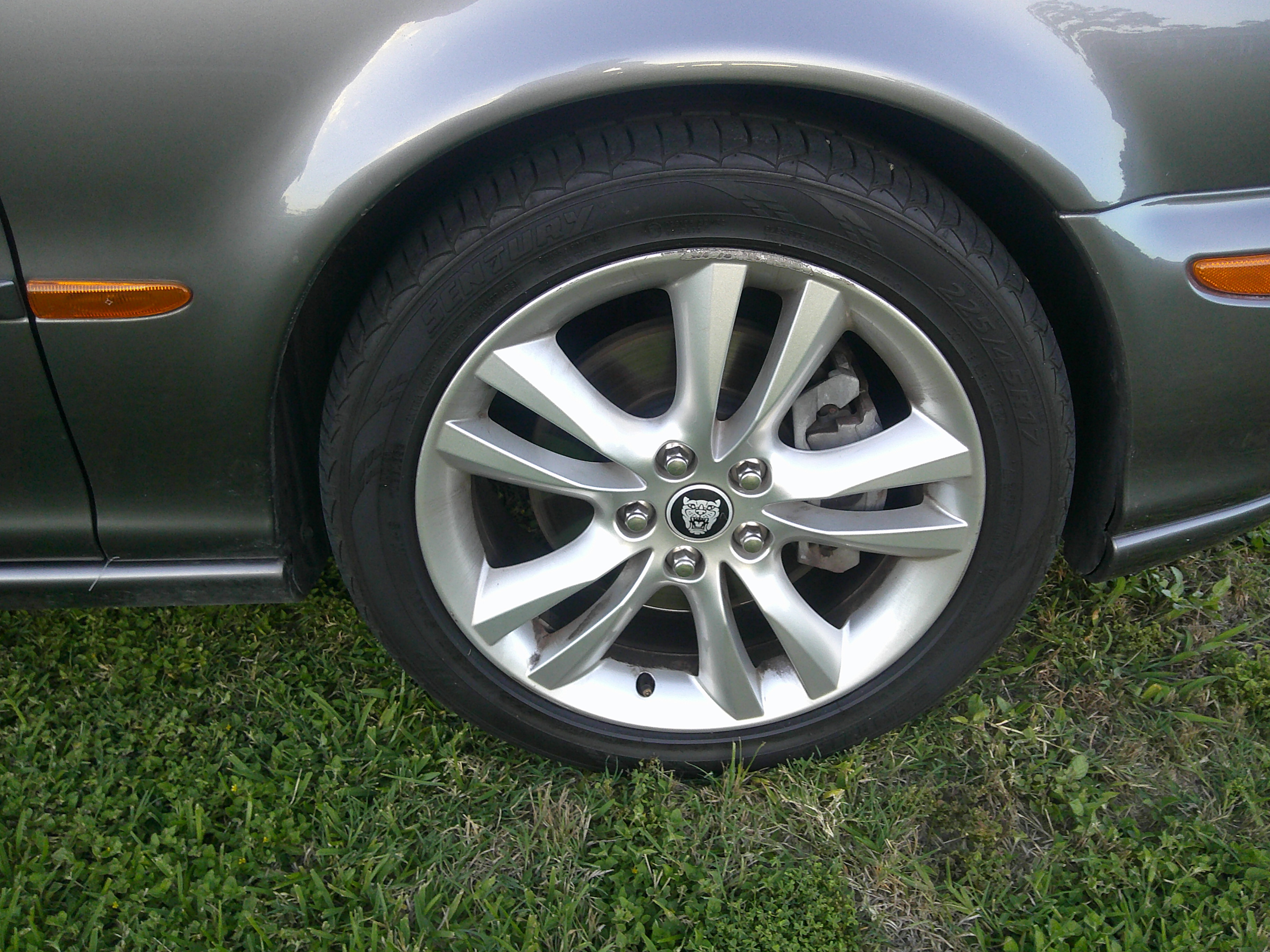 Jaguar alloy wheel and tire detail on gray exterior body