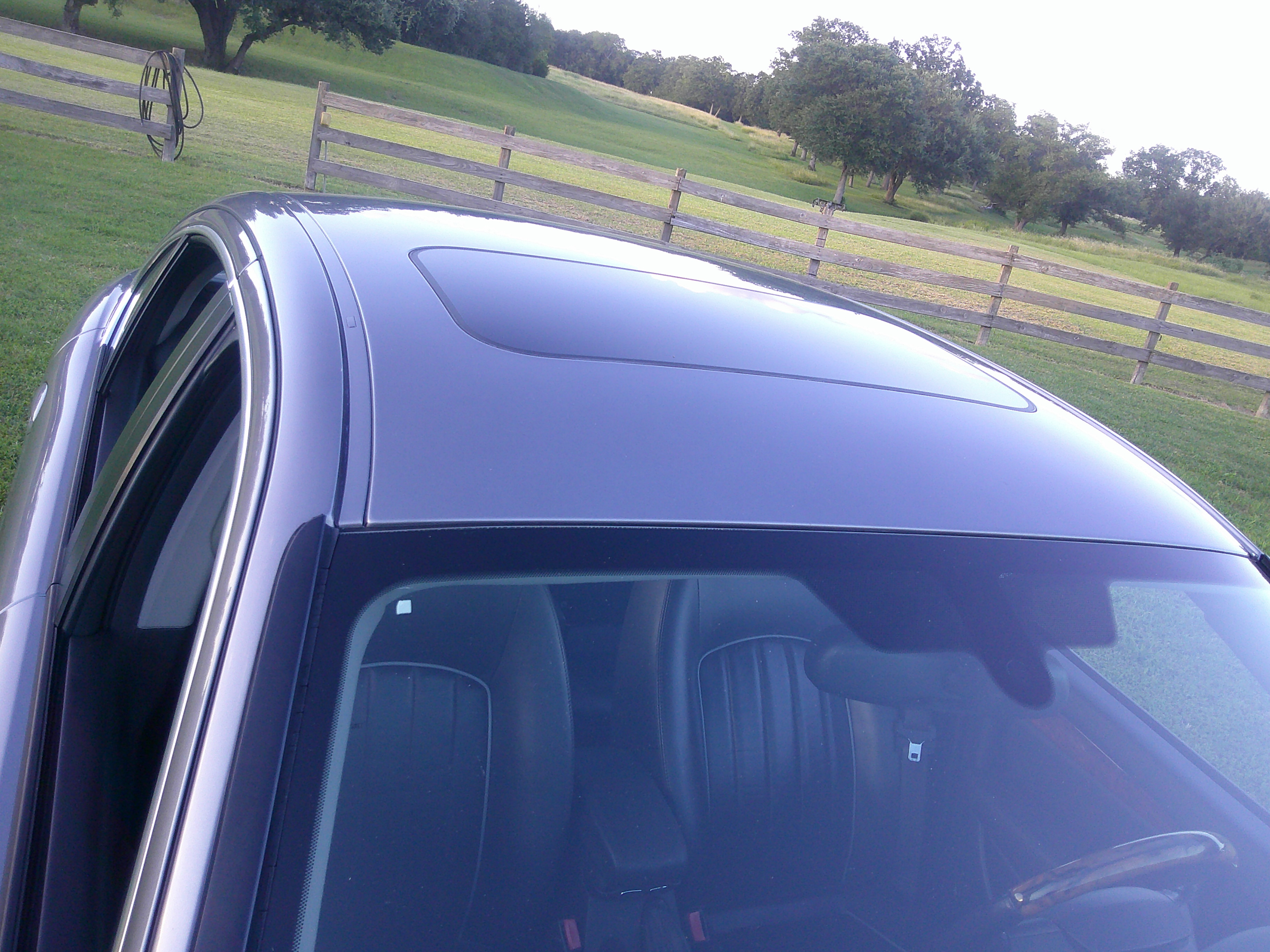 High angle shot of the vehicle roof featuring the sunroof and windshield.