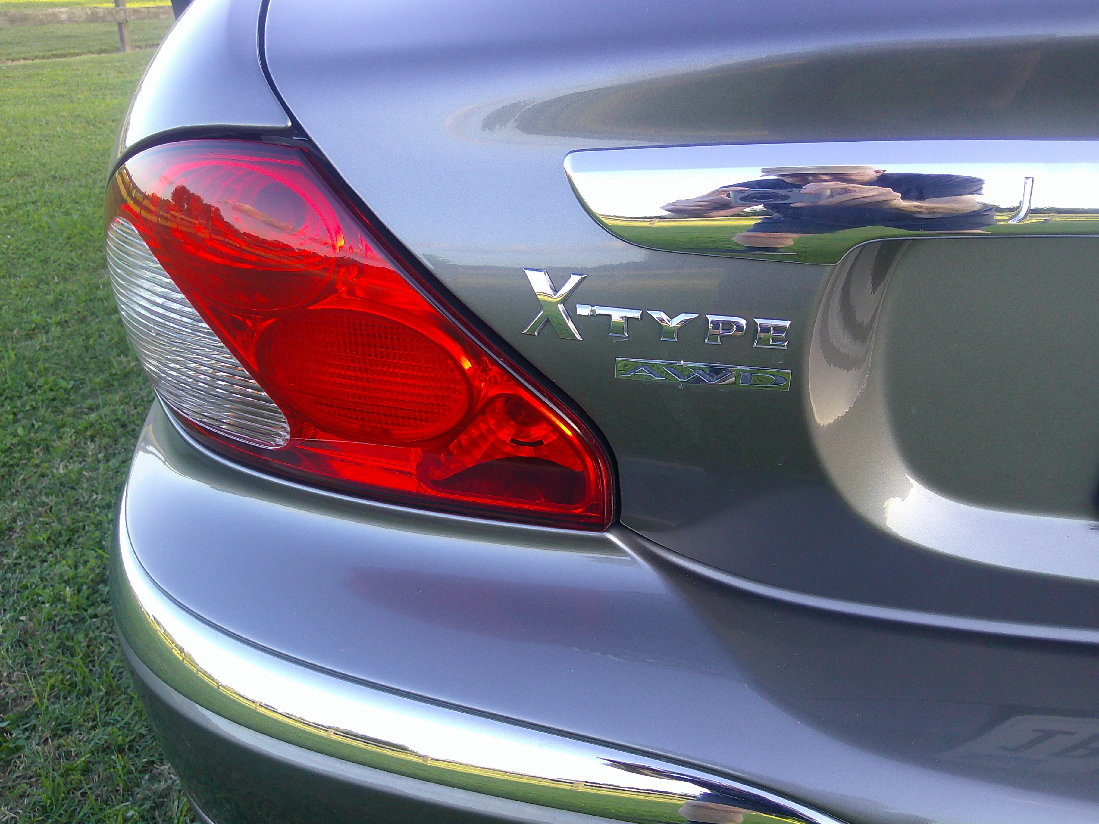 Rear left taillight and X-Type AWD badging on trunk lid