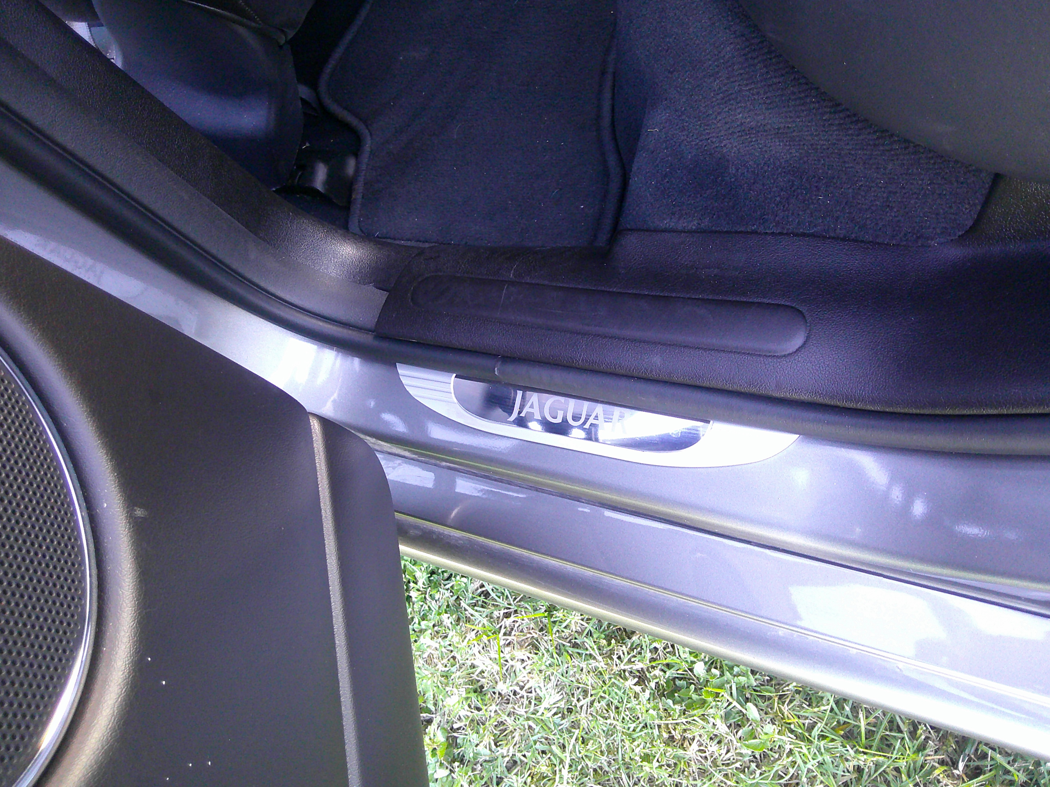 Jaguar branded door sill plate and floor mat.