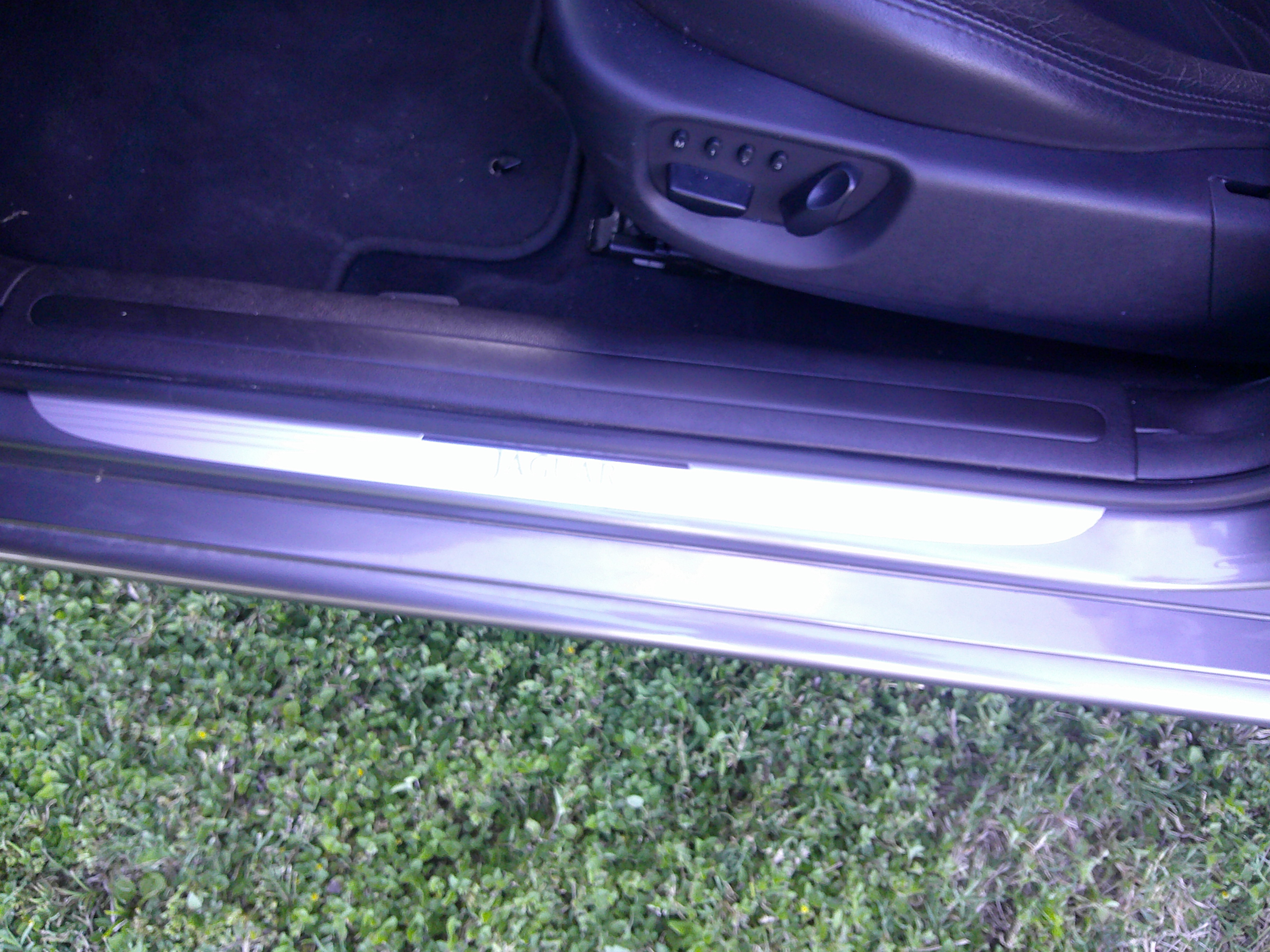 View of the door sill and front seat adjustments