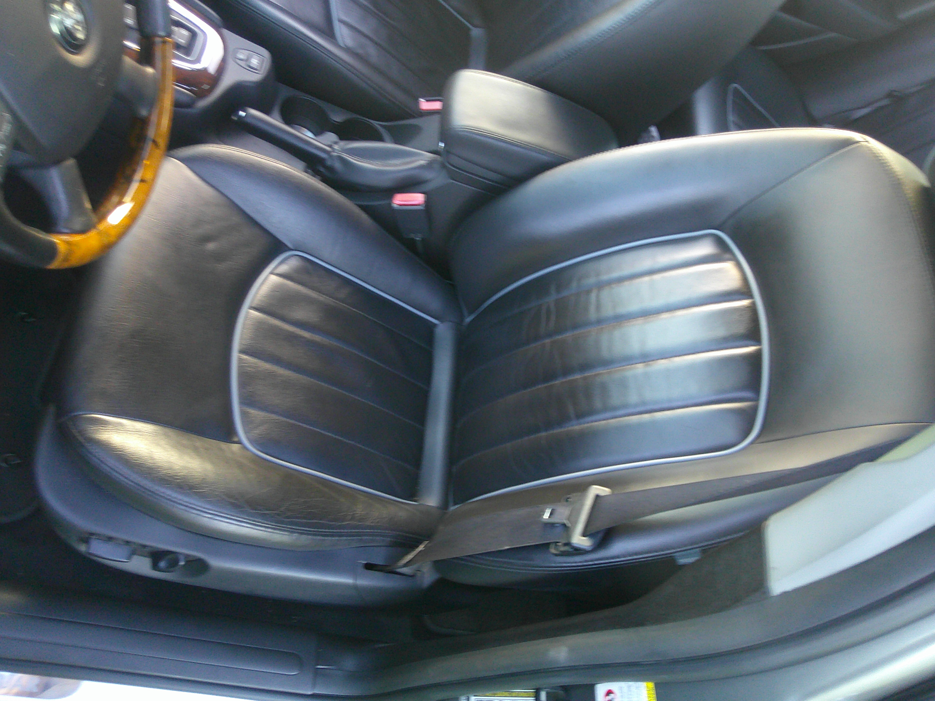 Black leather front passenger seat with grey piping