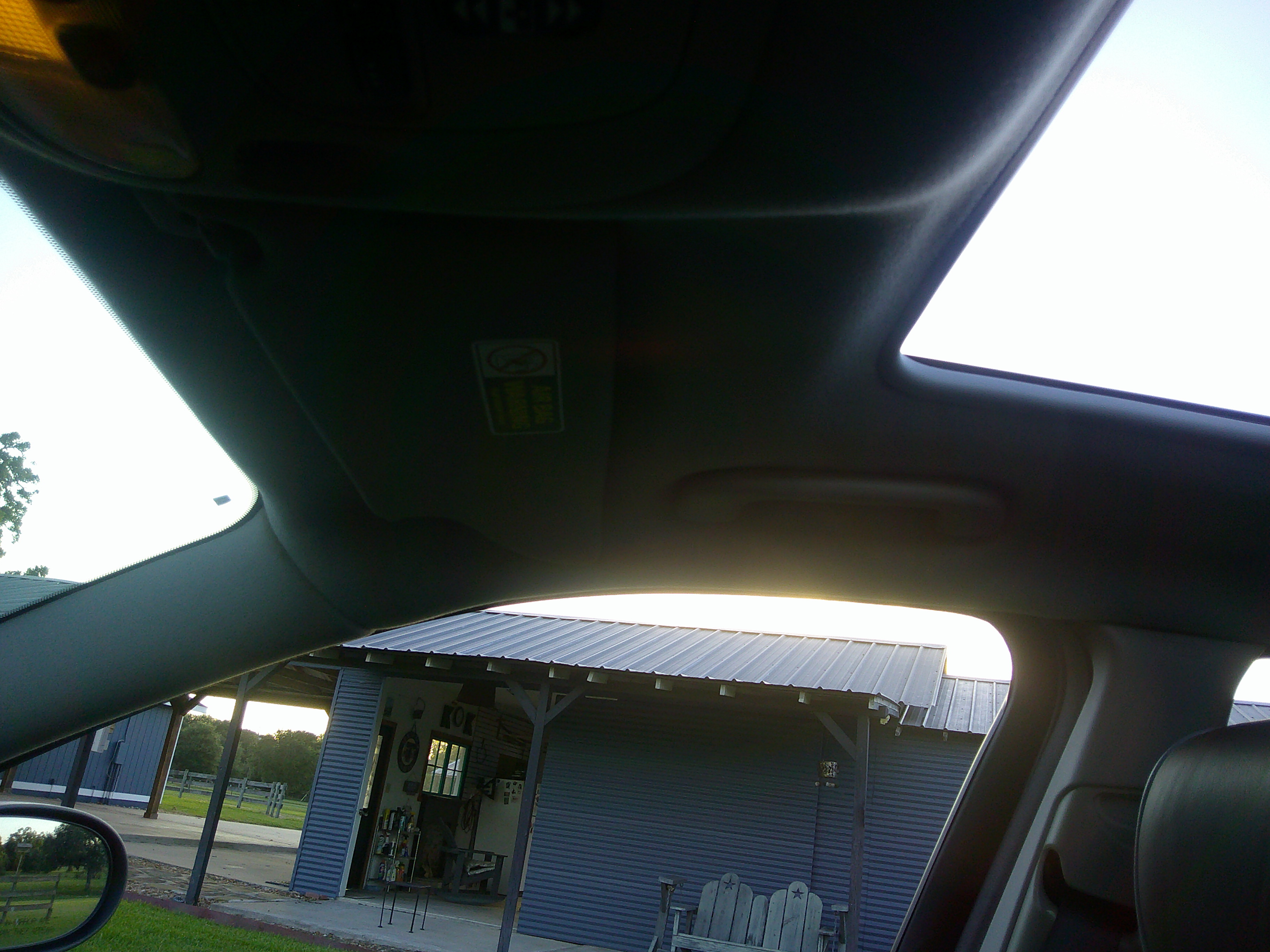 View of the headliner, sun visor, and sunroof opening.