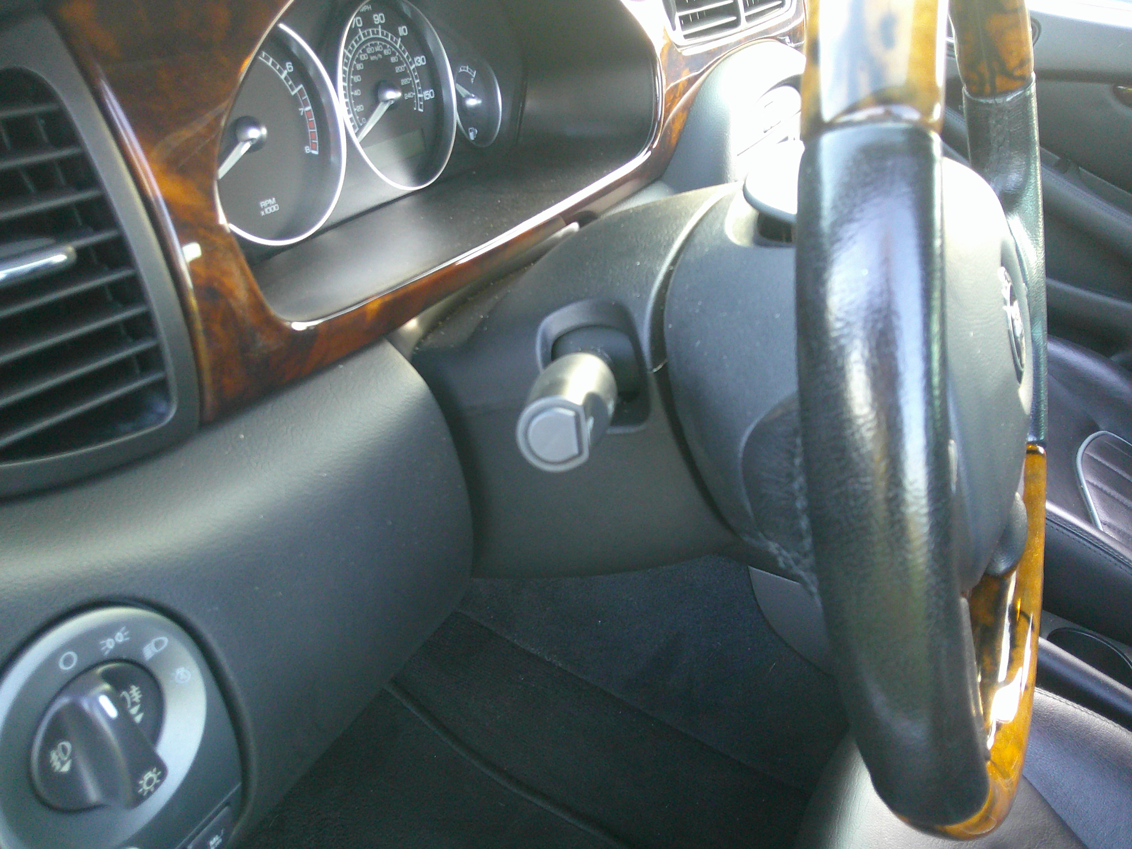 Driver's side view of the dashboard, steering column, and instrument cluster.
