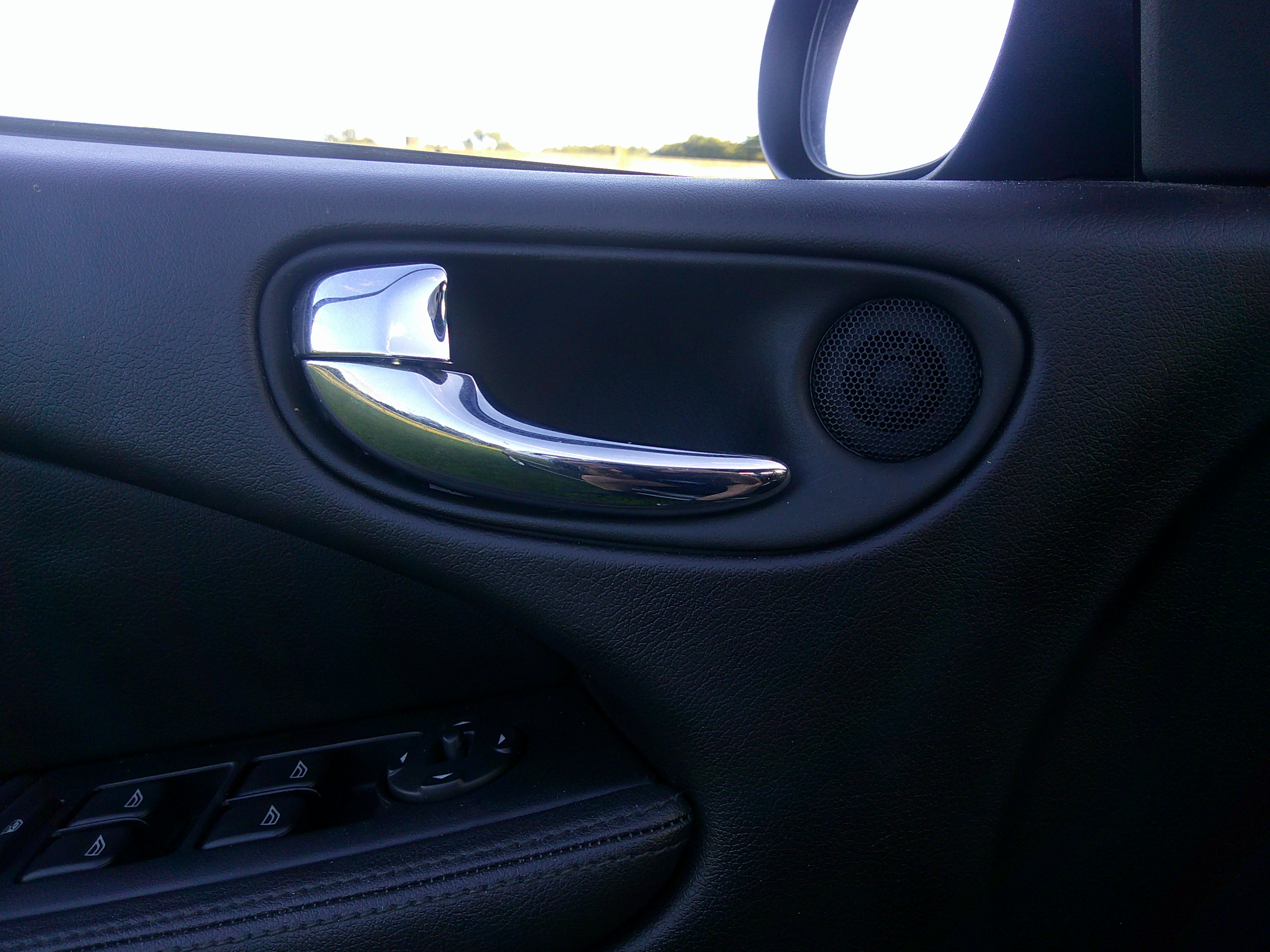 Chrome interior door handle and window control panel