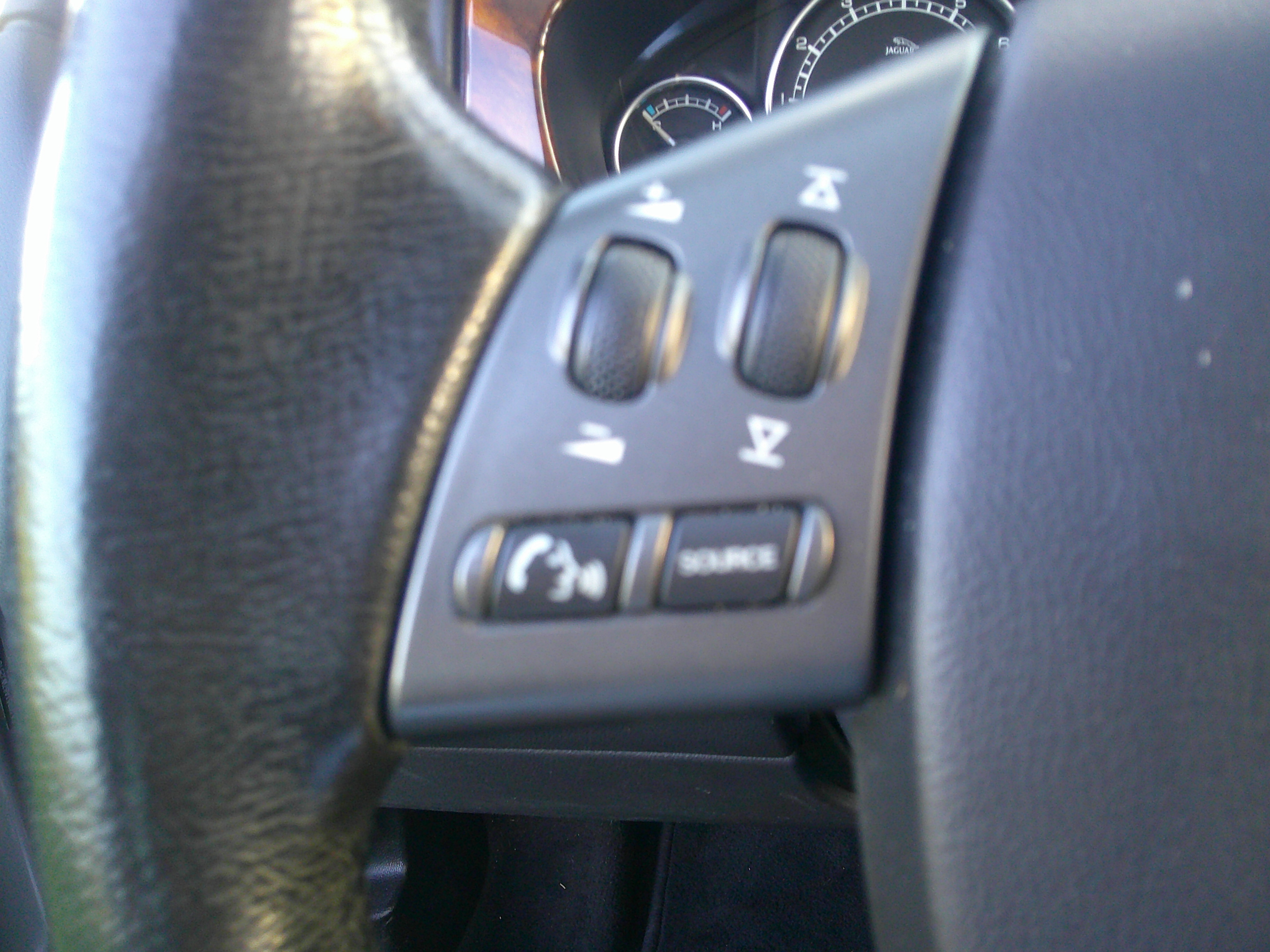 Close-up of steering wheel mounted audio and phone controls