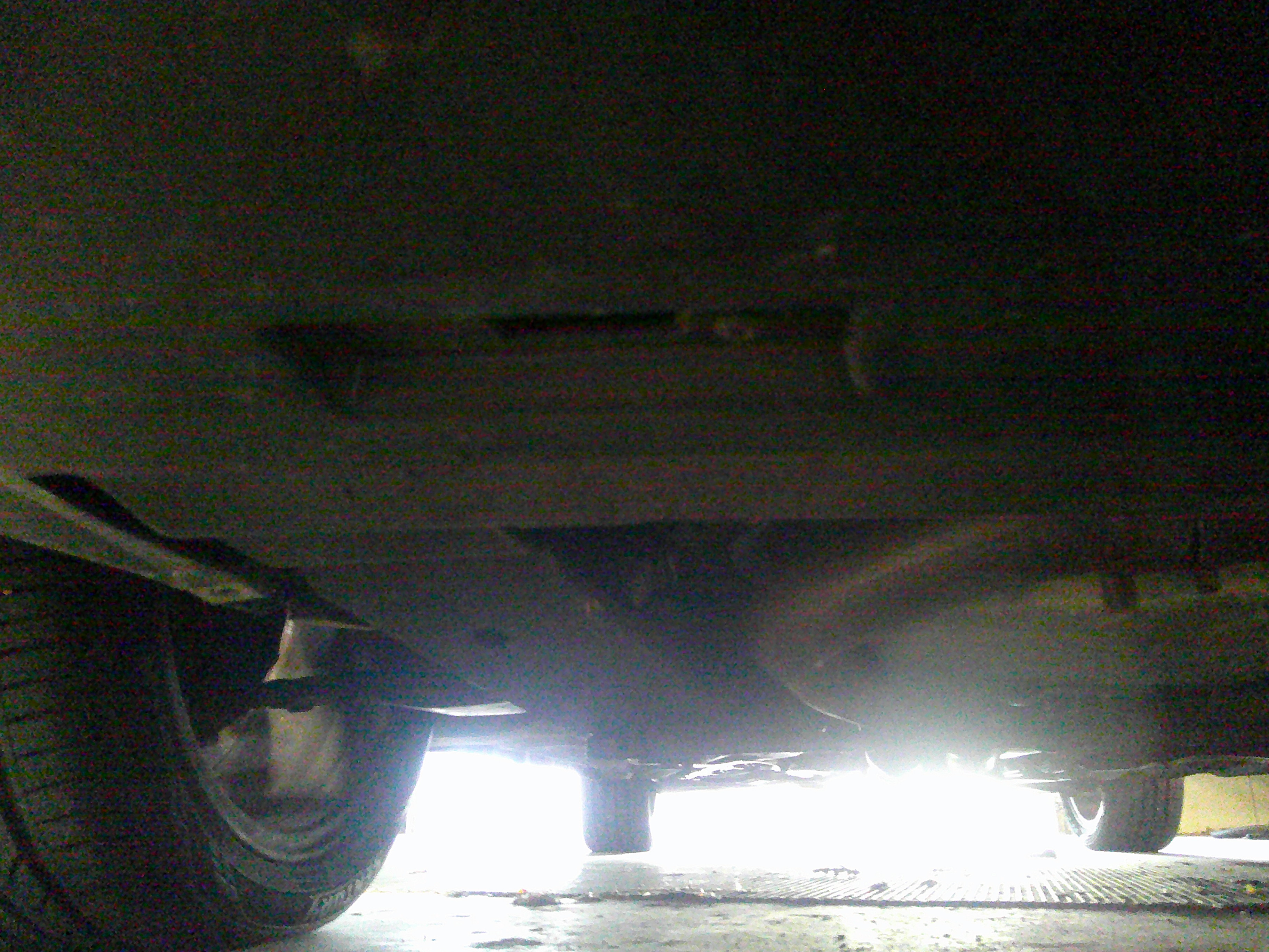 Underbody view showing chassis, suspension components, and tires