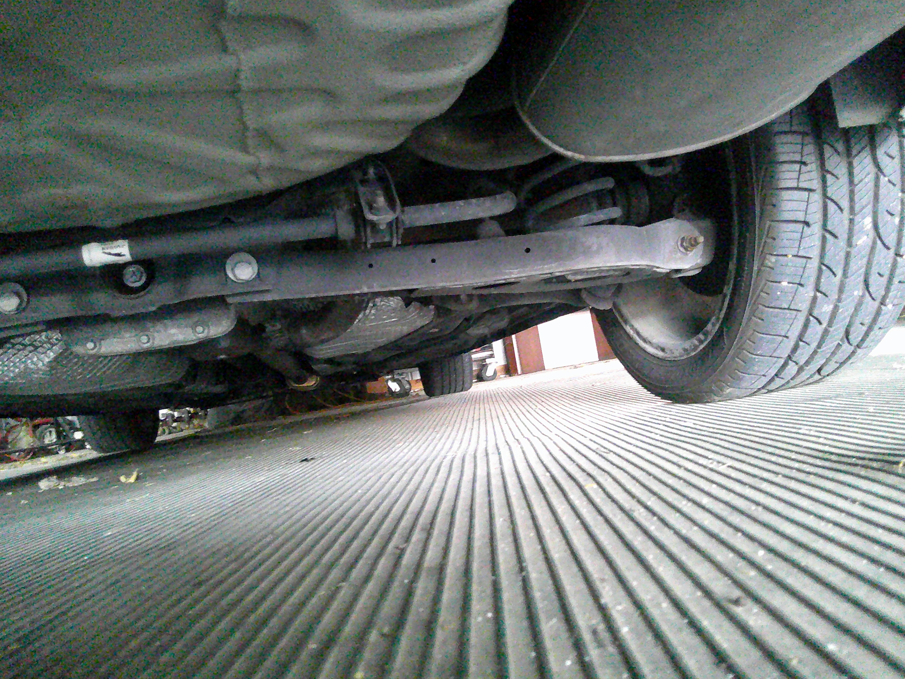 Underside view showing rear suspension components and tire tread.