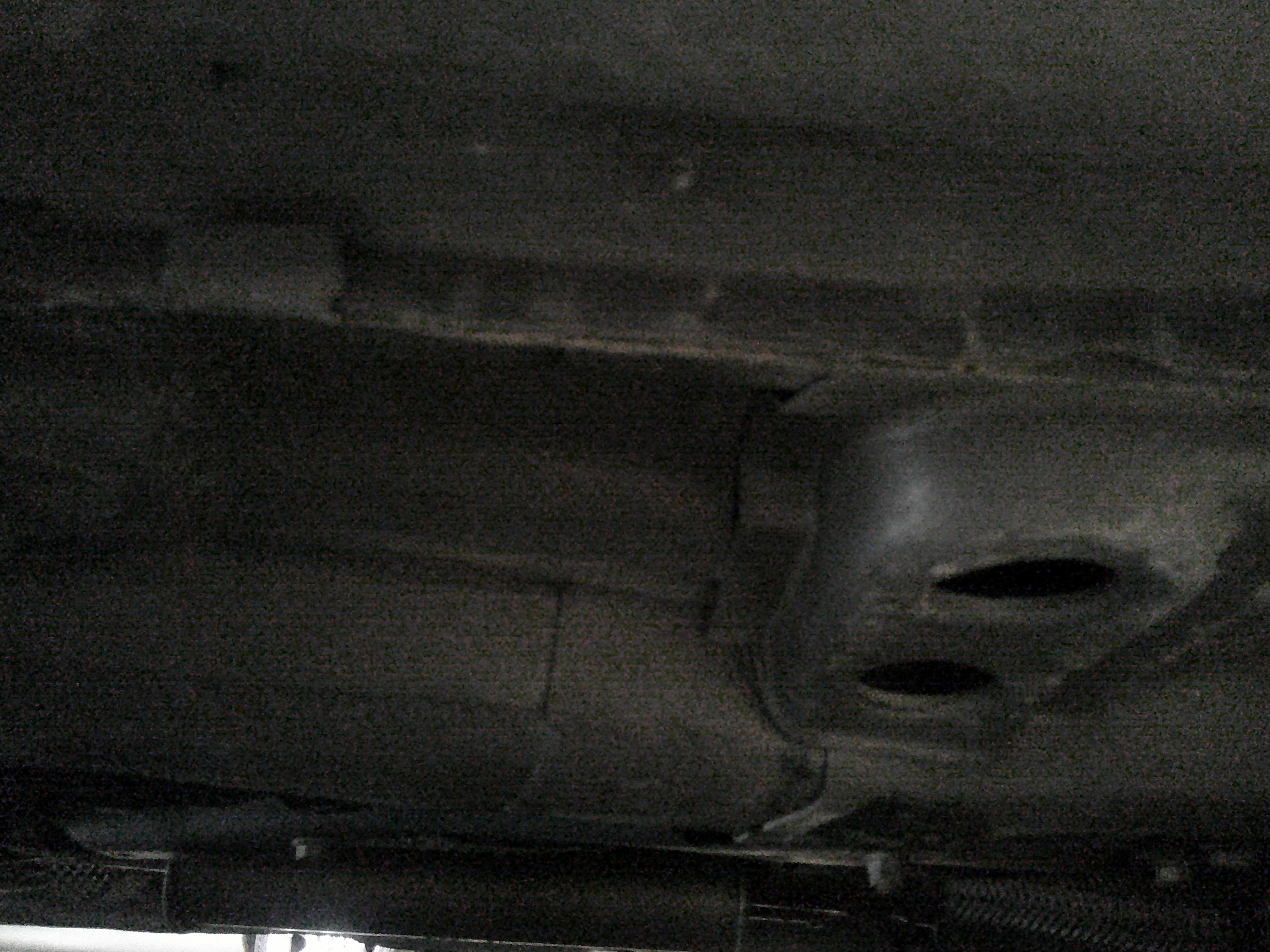 Detail view of the vehicle floor pan and undercarriage components.