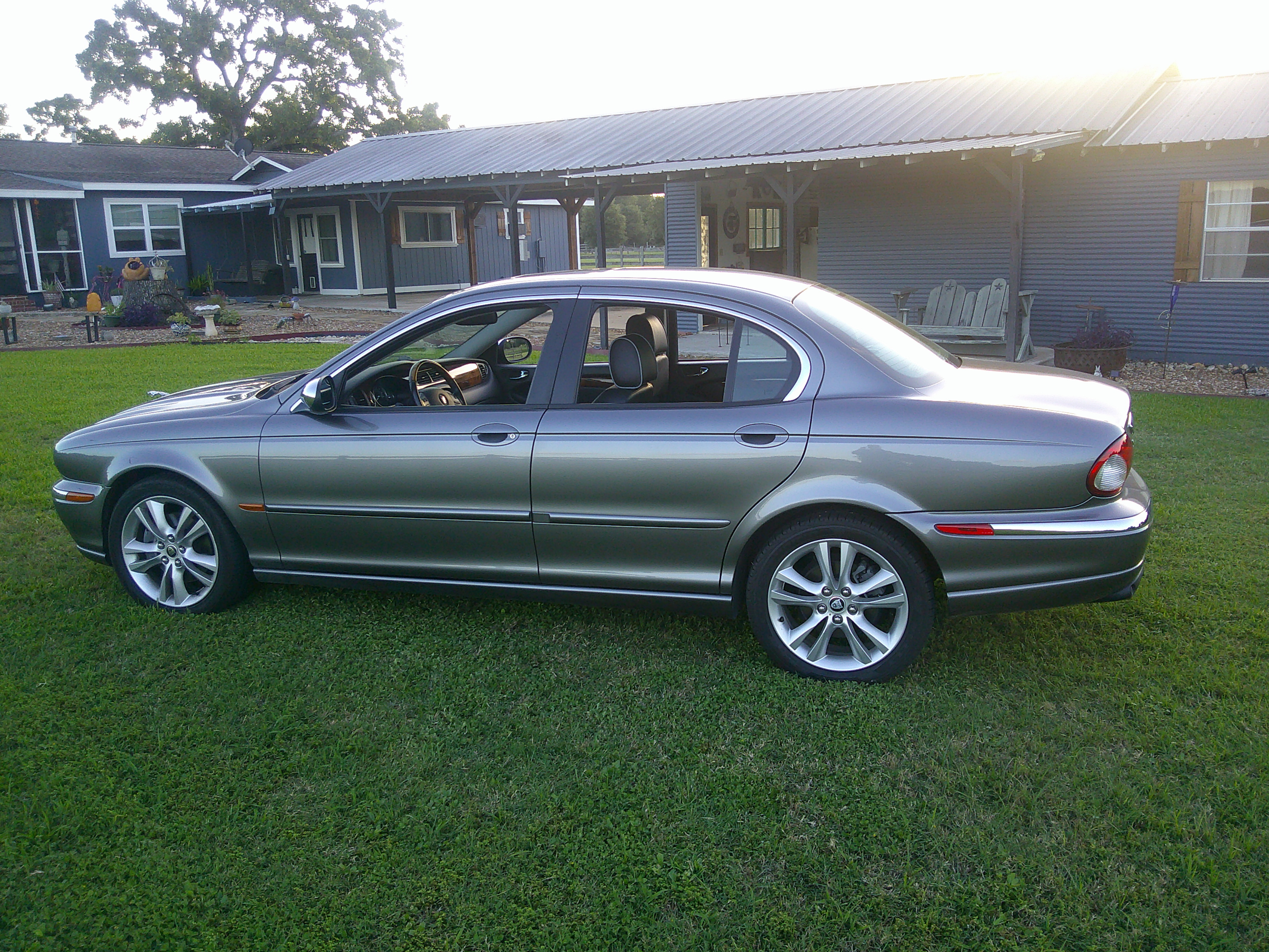 Full profile view of a grey Jaguar S-Type sedan.