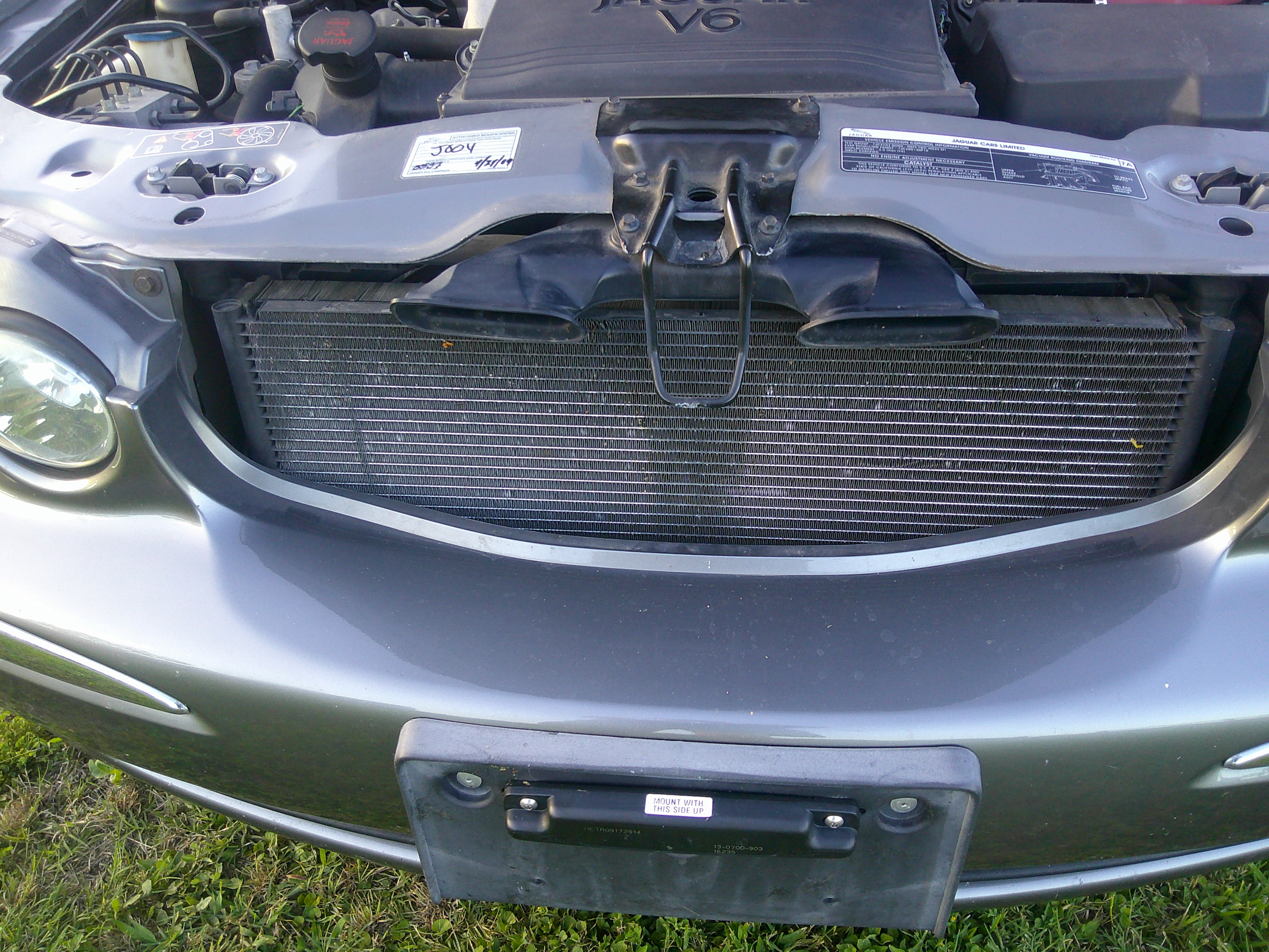 View of the radiator, radiator support, and engine intake ducts