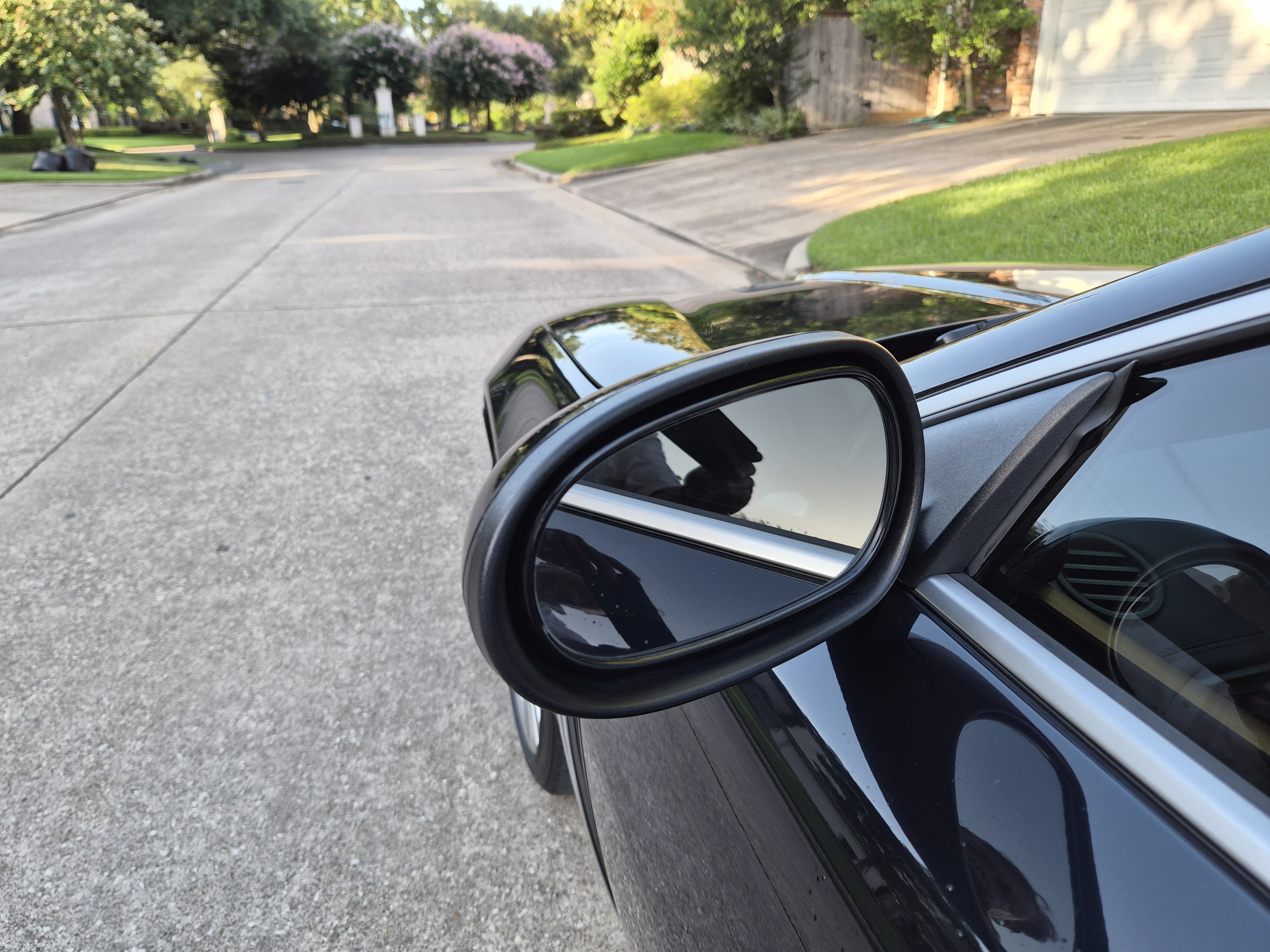 Close-up of the driver side wing mirror and door trim.