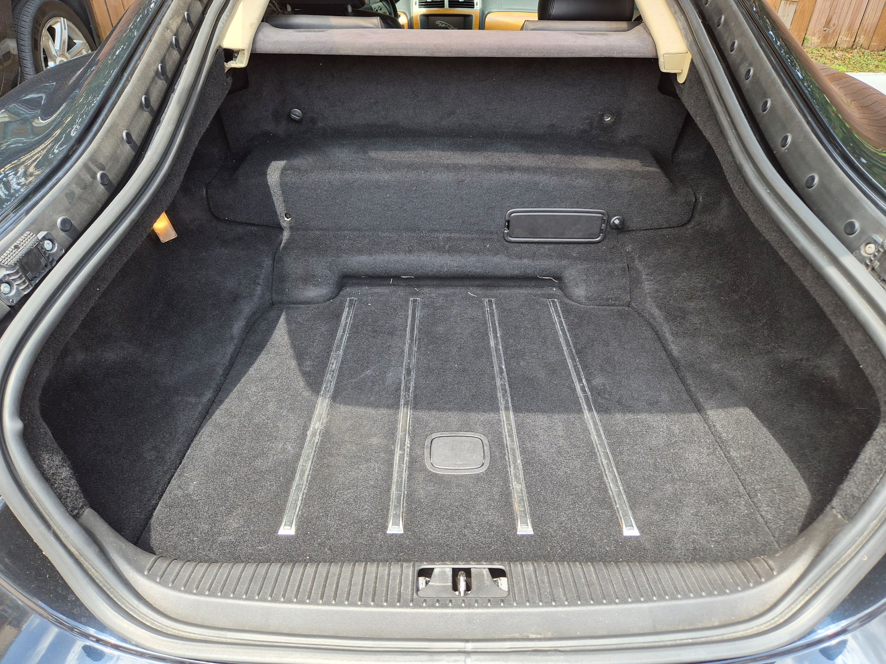 Rear cargo area with carpeted floor and metal runners