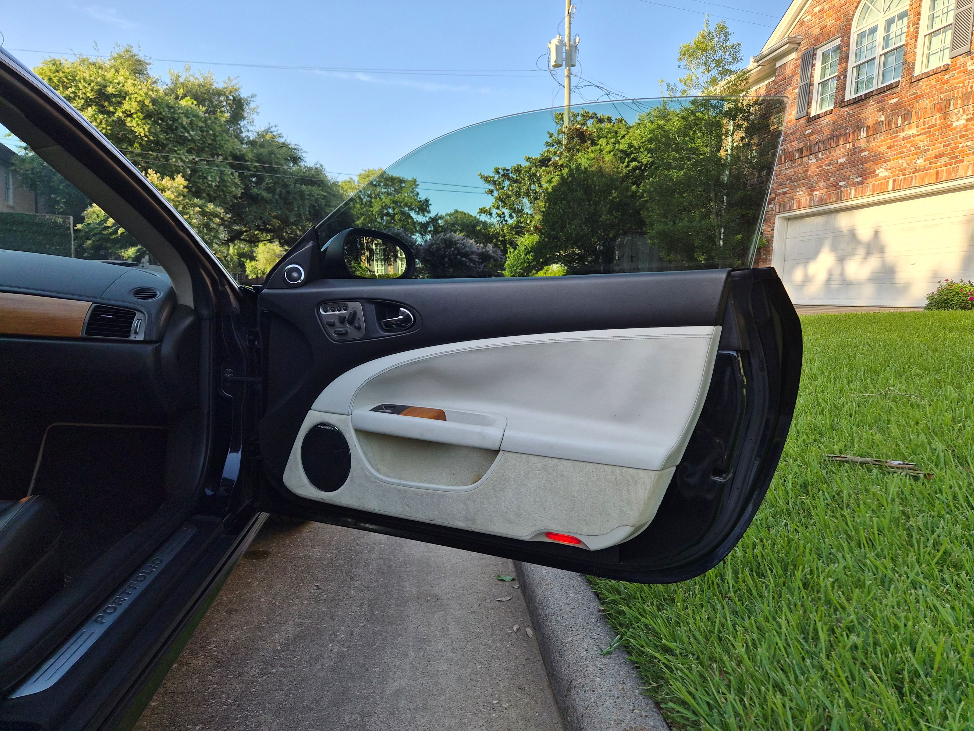 Driver side door panel upholstered in two-tone leather.