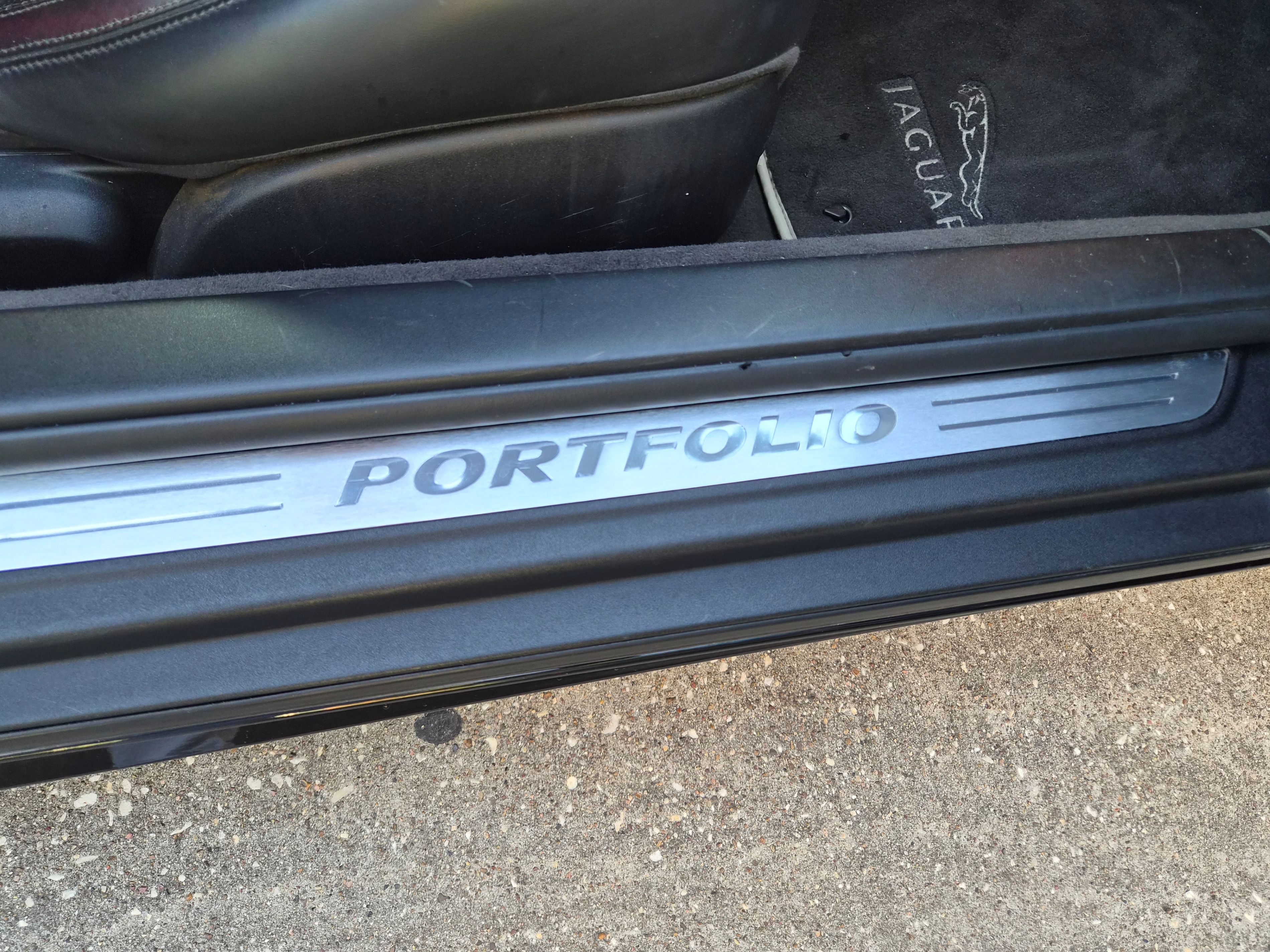 Door sill plate with Portfolio branding and Jaguar floor mat