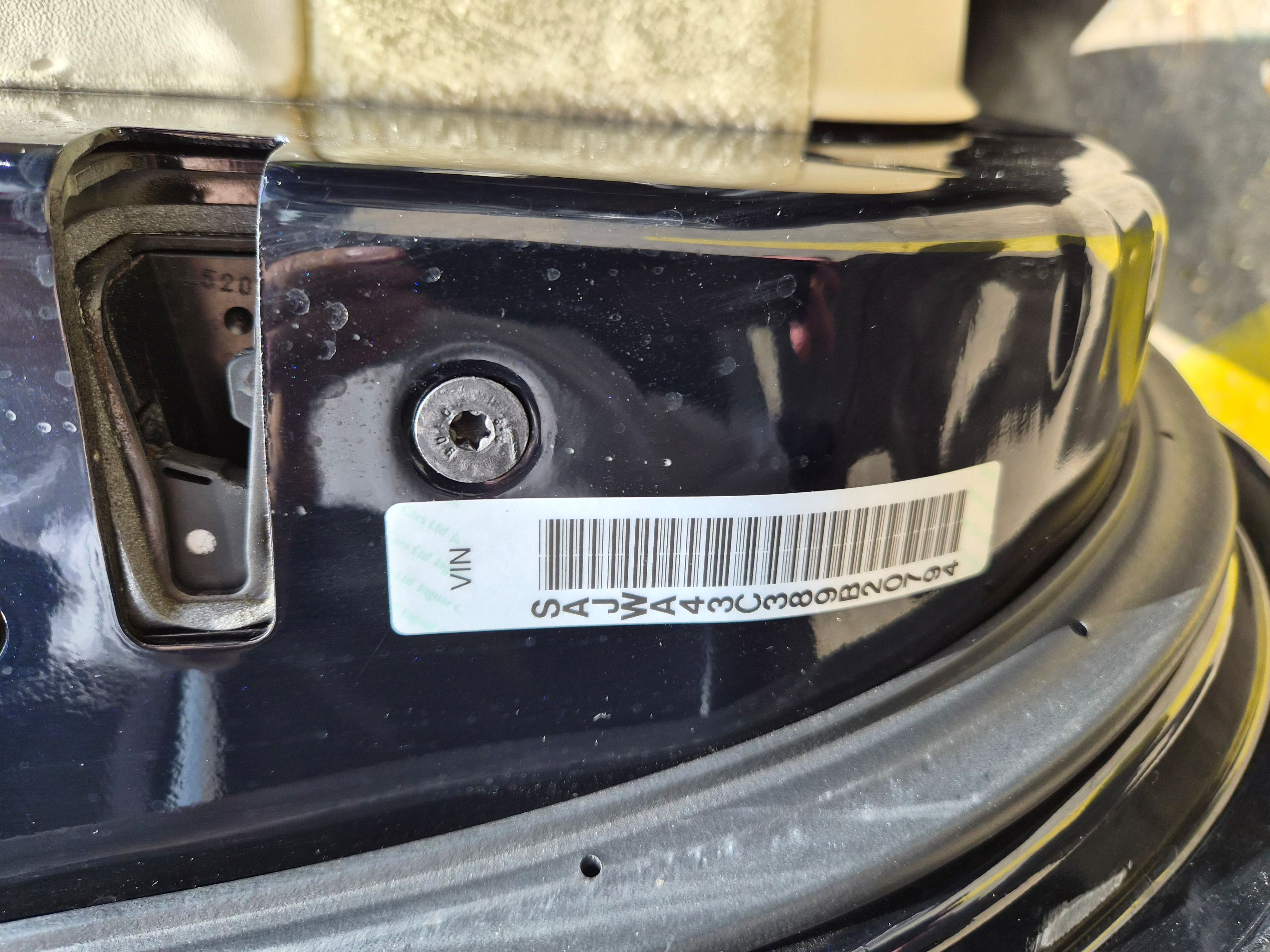 Vehicle Identification Number (VIN) sticker and barcode on door jamb