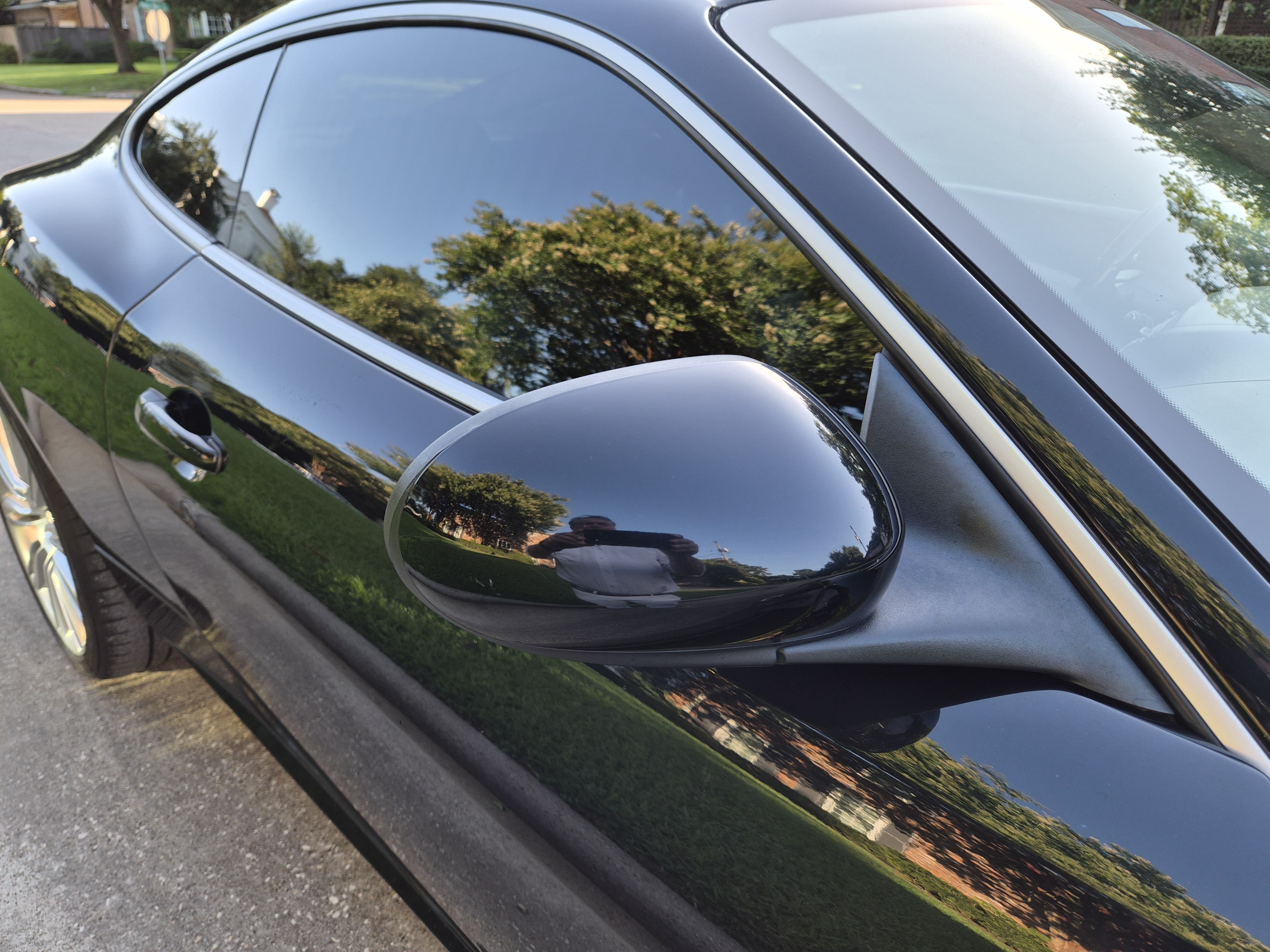 Driver side view showing side mirror, door handle, and window trim.