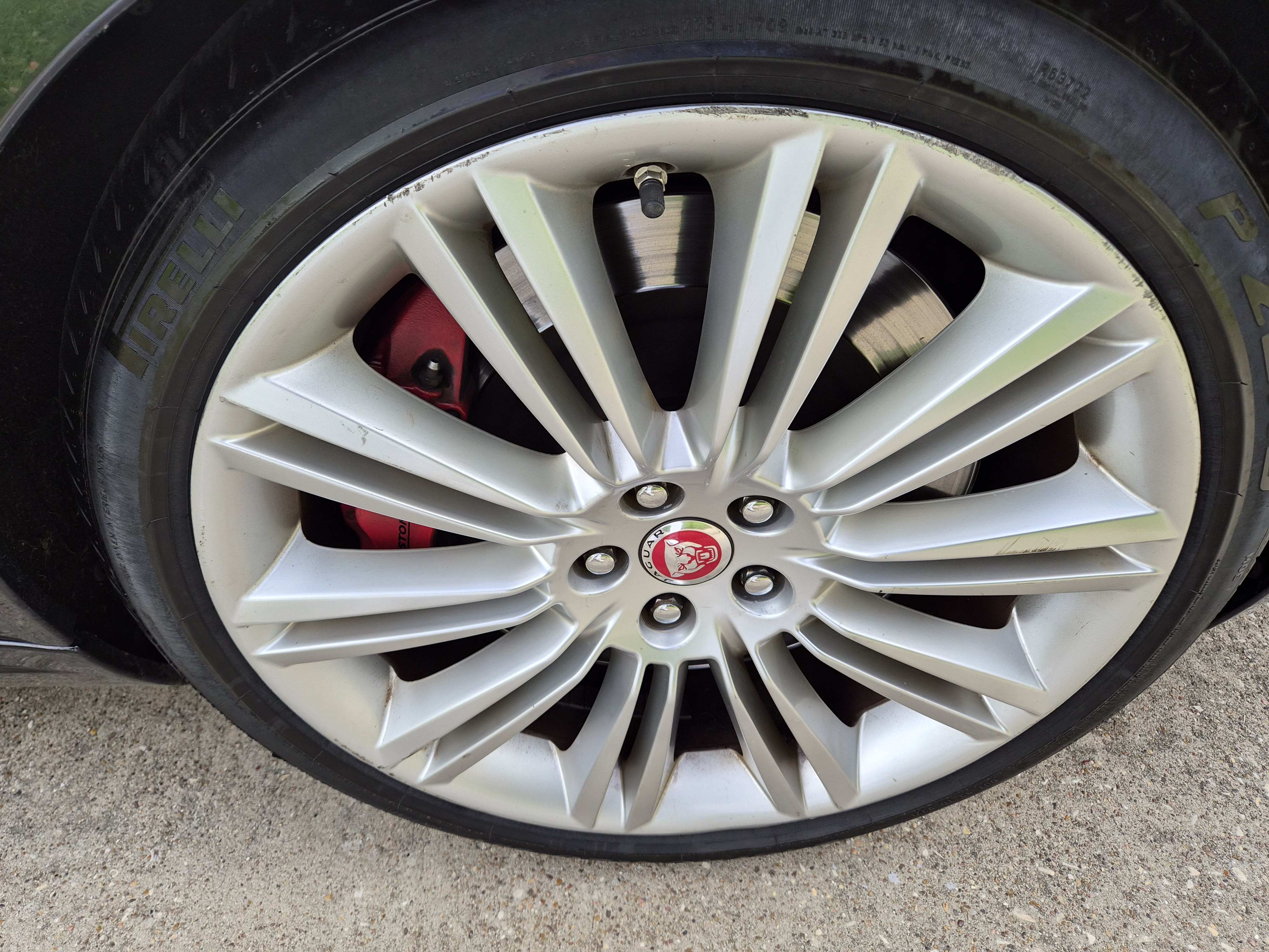 Jaguar alloy wheel with red brake caliper and Pirelli tire
