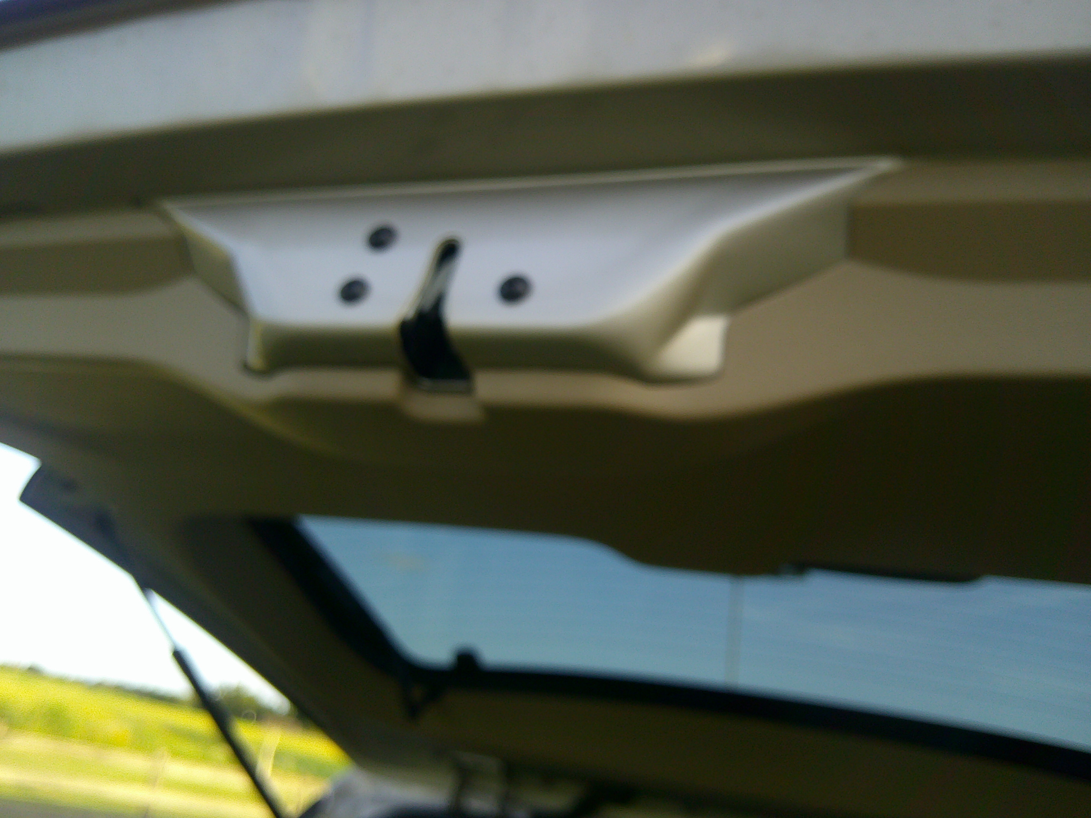 Rear tailgate latch mechanism with mounting screws