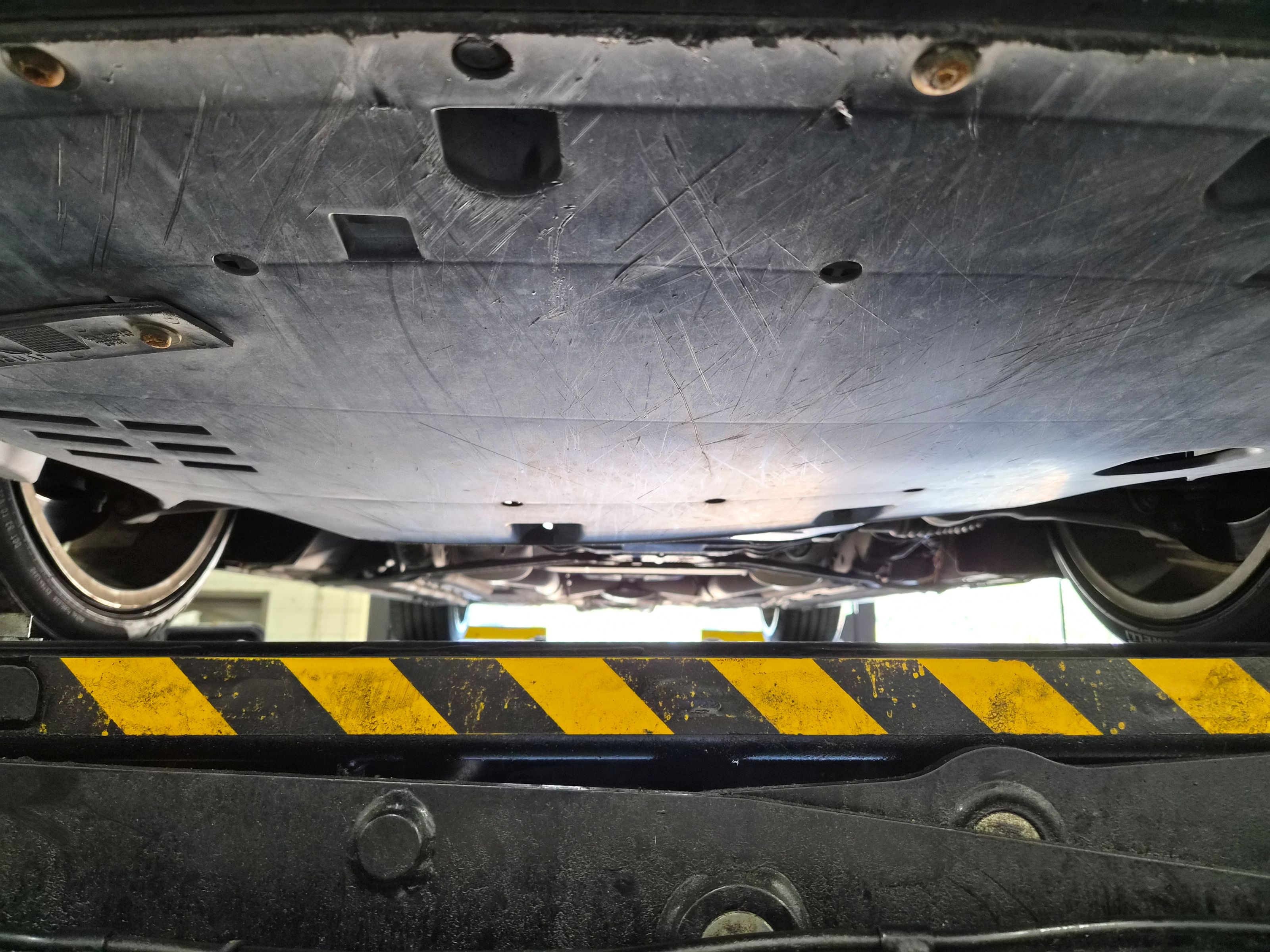 Underbody view showing protective belly pan and lower suspension components.
