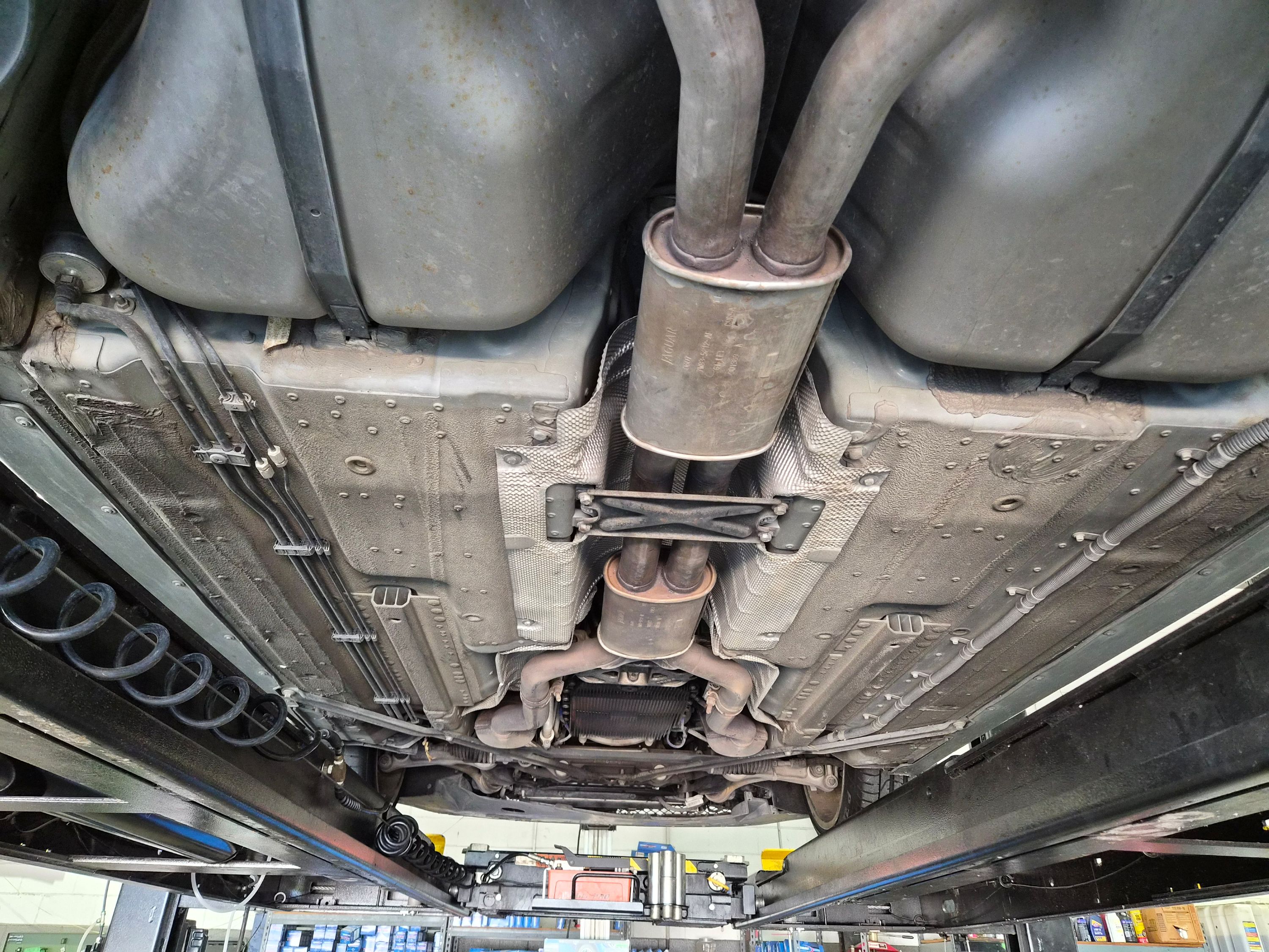 Underbody view showing chassis, exhaust system, and floor pans.