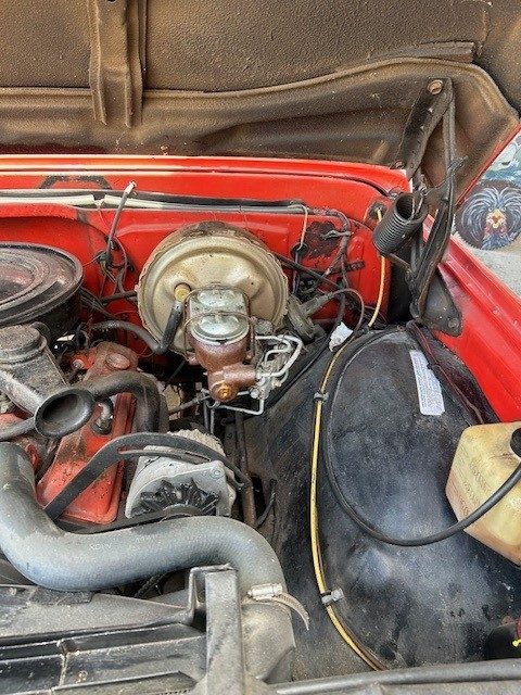 Engine bay view showing brake master cylinder and alternator.