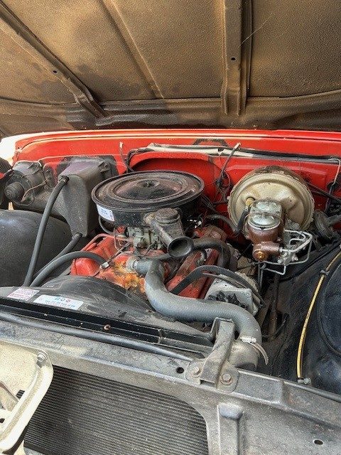 Engine bay showing V8 motor, air cleaner, and master cylinder