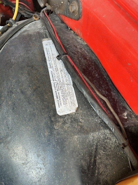Vehicle emission control information decal in engine bay