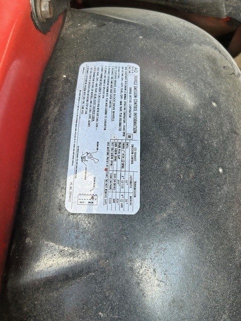 Vehicle emission control information decal in the engine bay