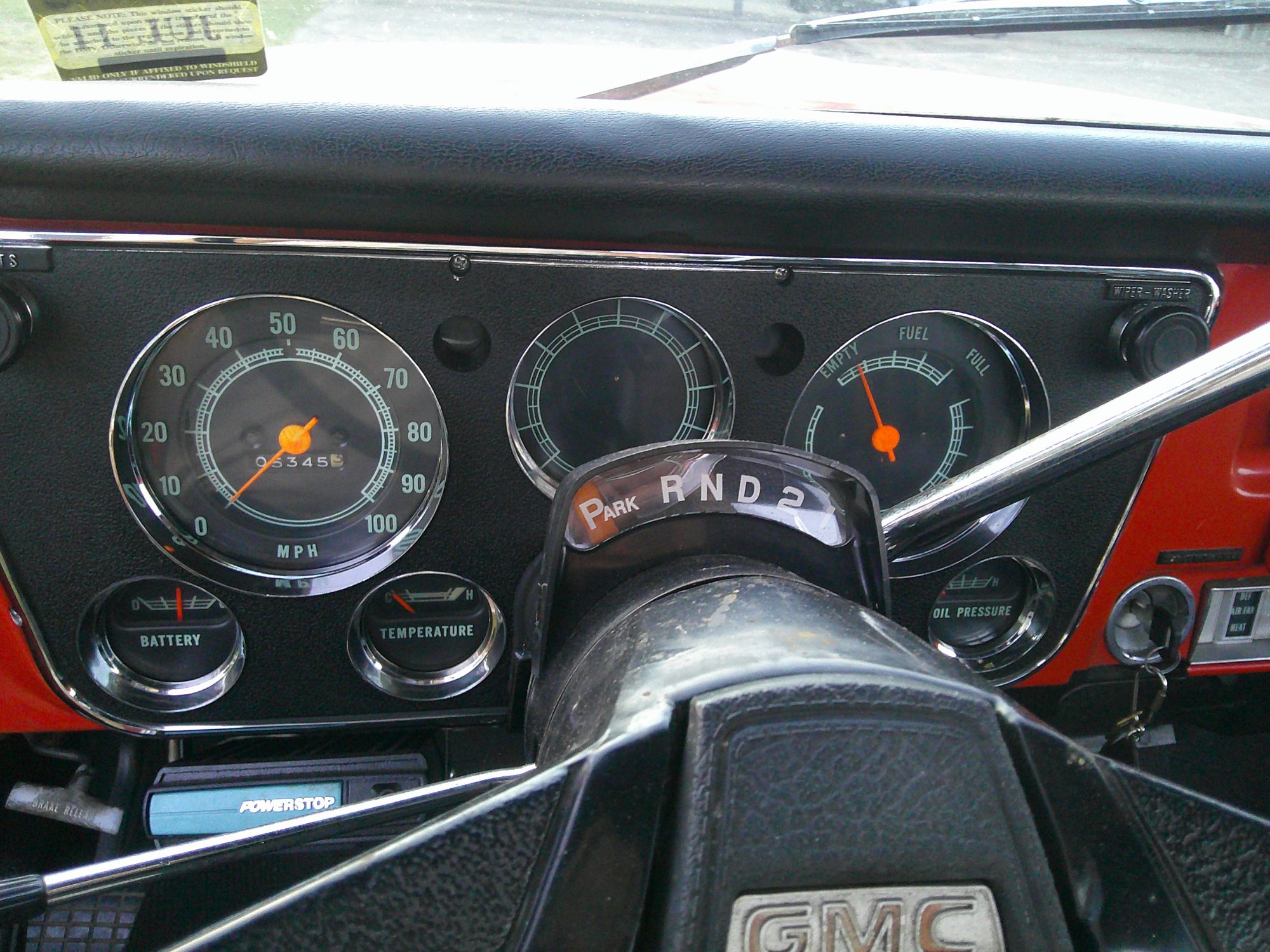 Classic GMC truck instrument cluster with speedometer and gear selector.