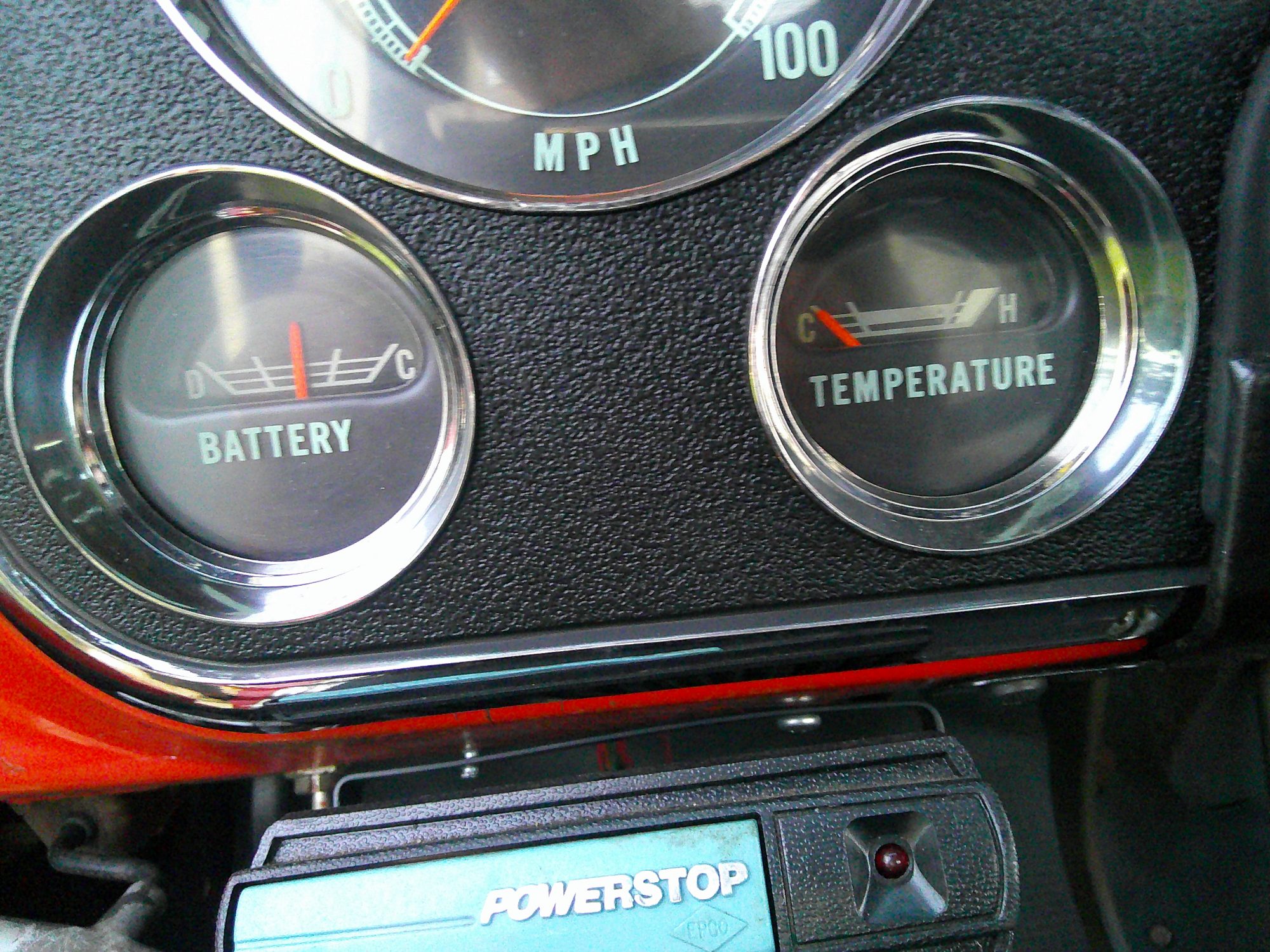 Close-up of dashboard battery and temperature gauges with Powerstop controller.