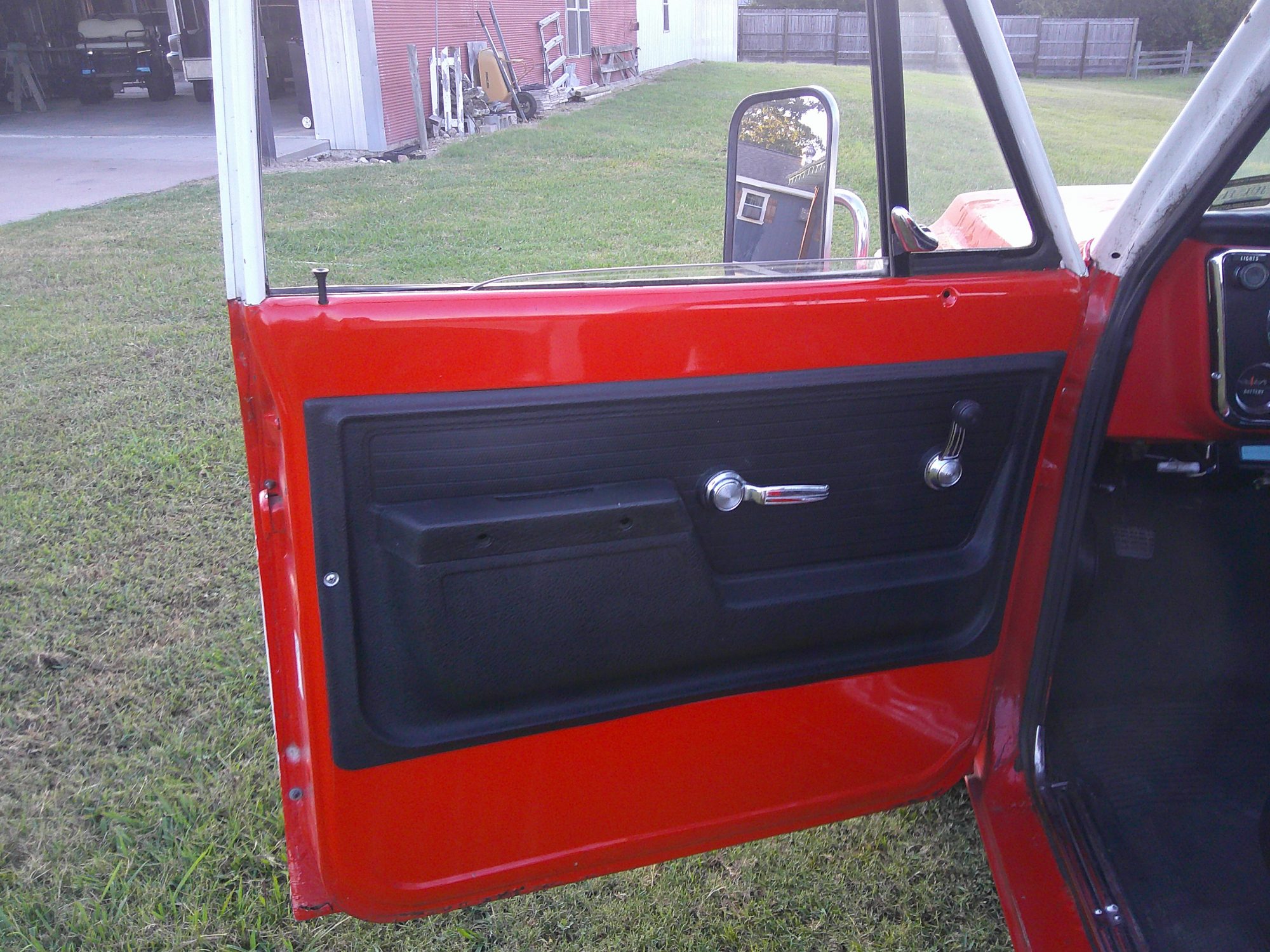Driver side interior door panel with manual window crank and chrome handle