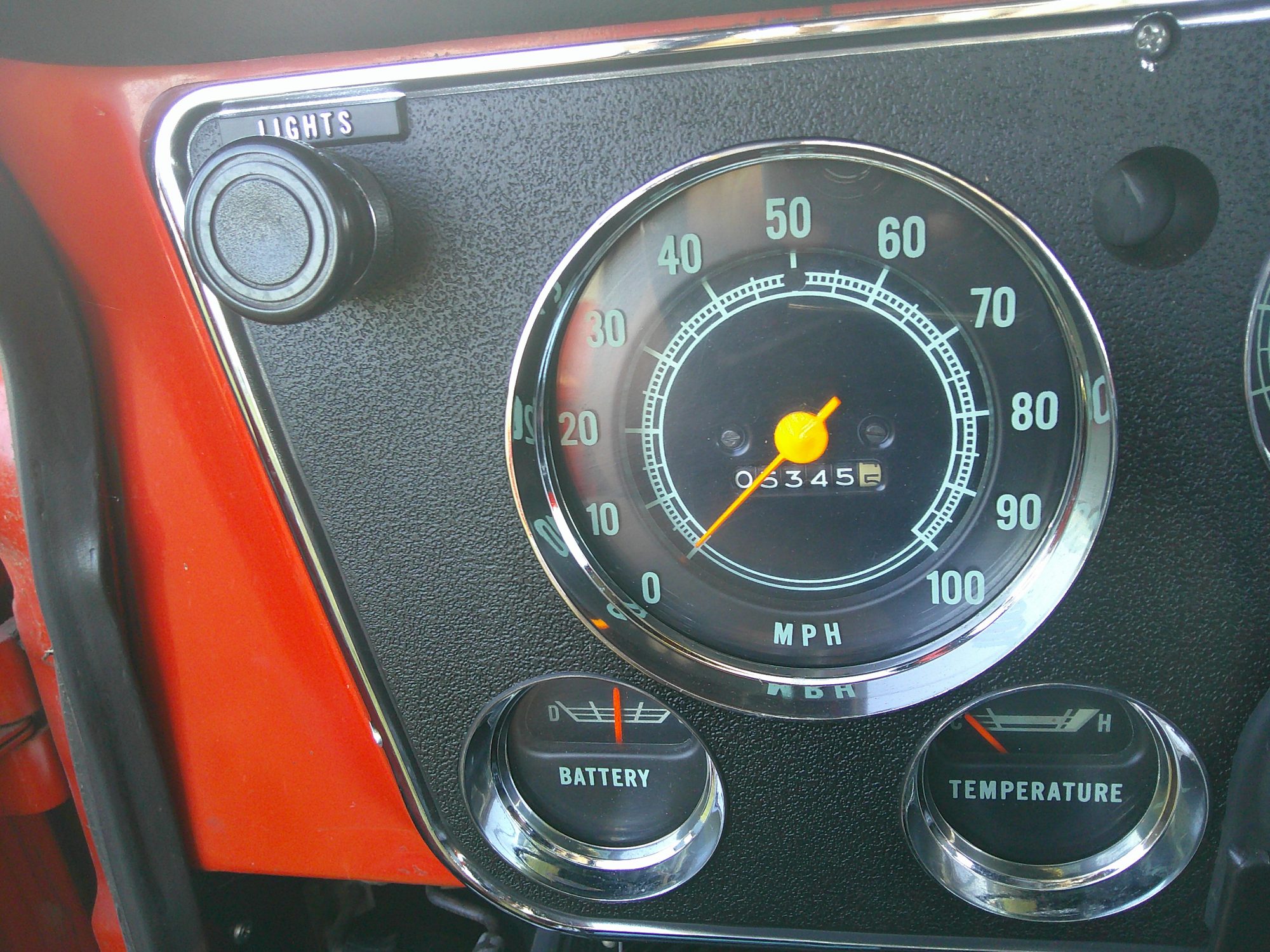 Instrument cluster showing speedometer, battery gauge, and temperature gauge.