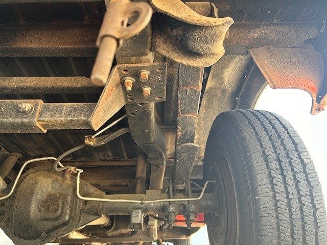 Rear chassis view showing leaf springs, axle, and differential housing.