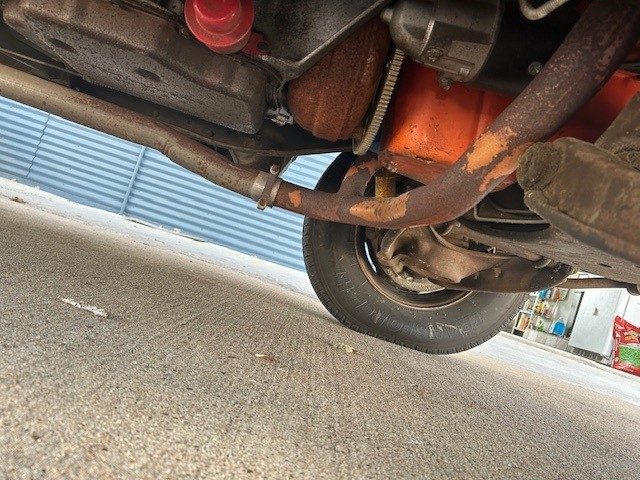 Undercarriage view of transmission, exhaust, and engine oil pan